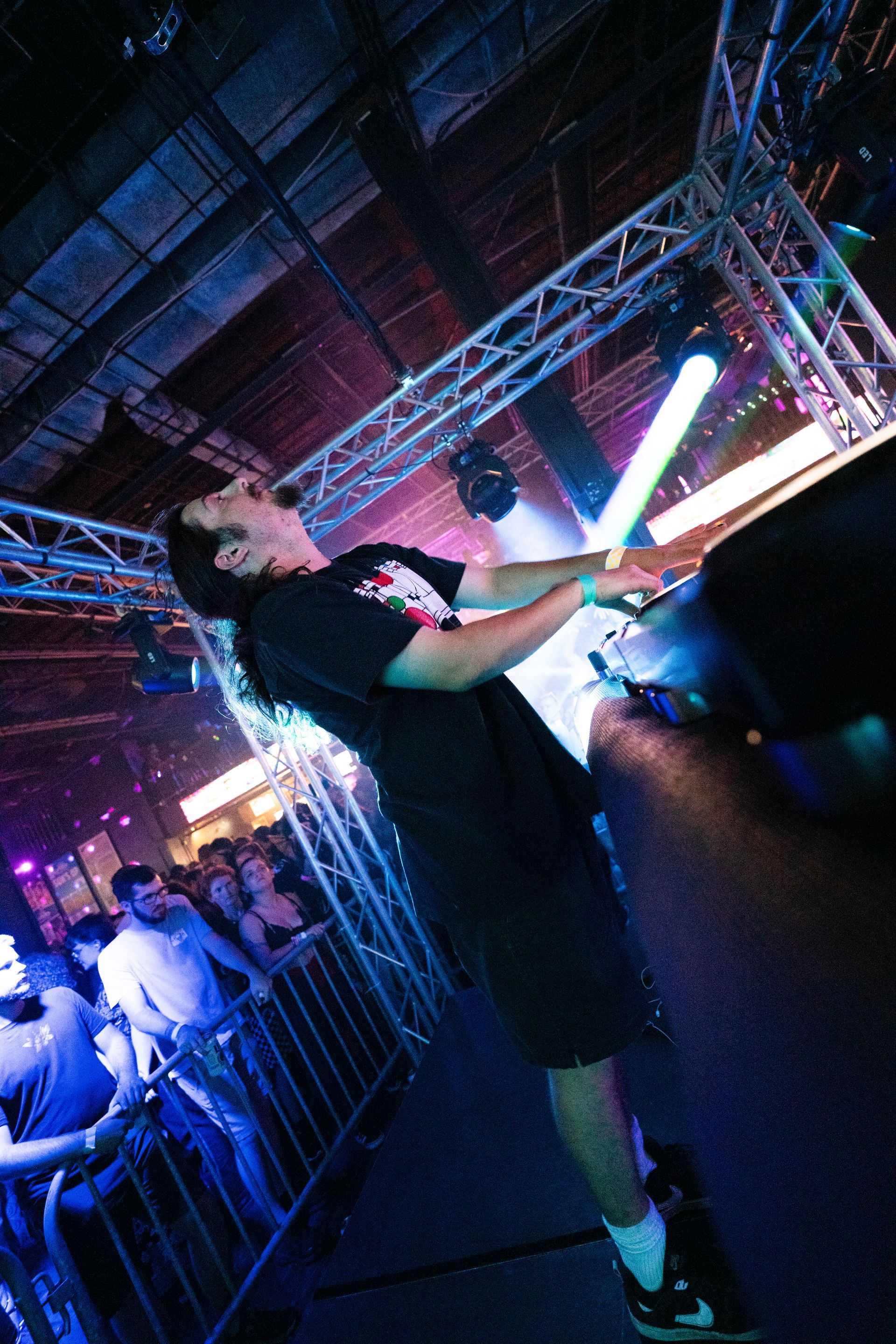 A man is holding a light stick in a dark room.