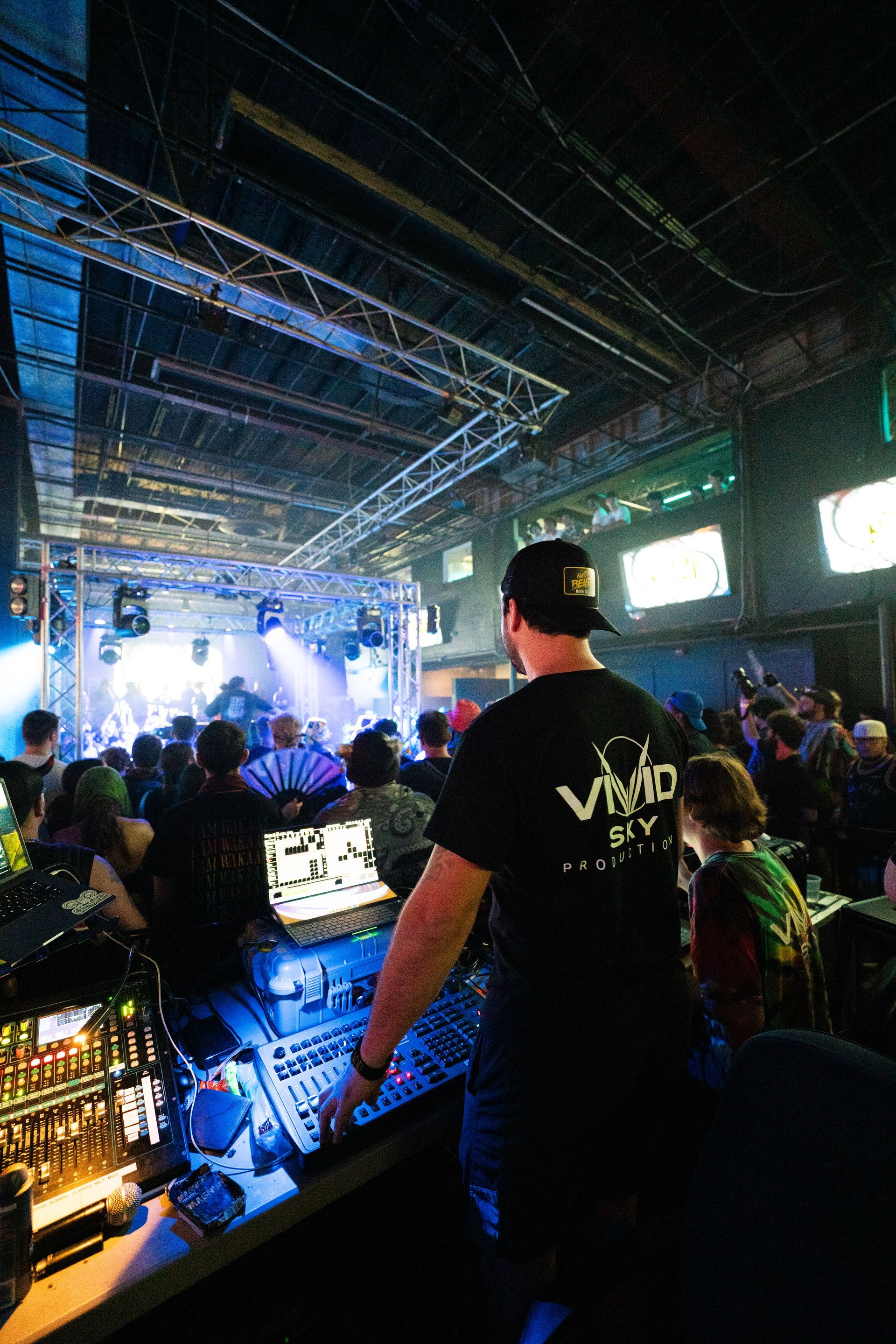 A man is standing in front of a crowd at a concert.