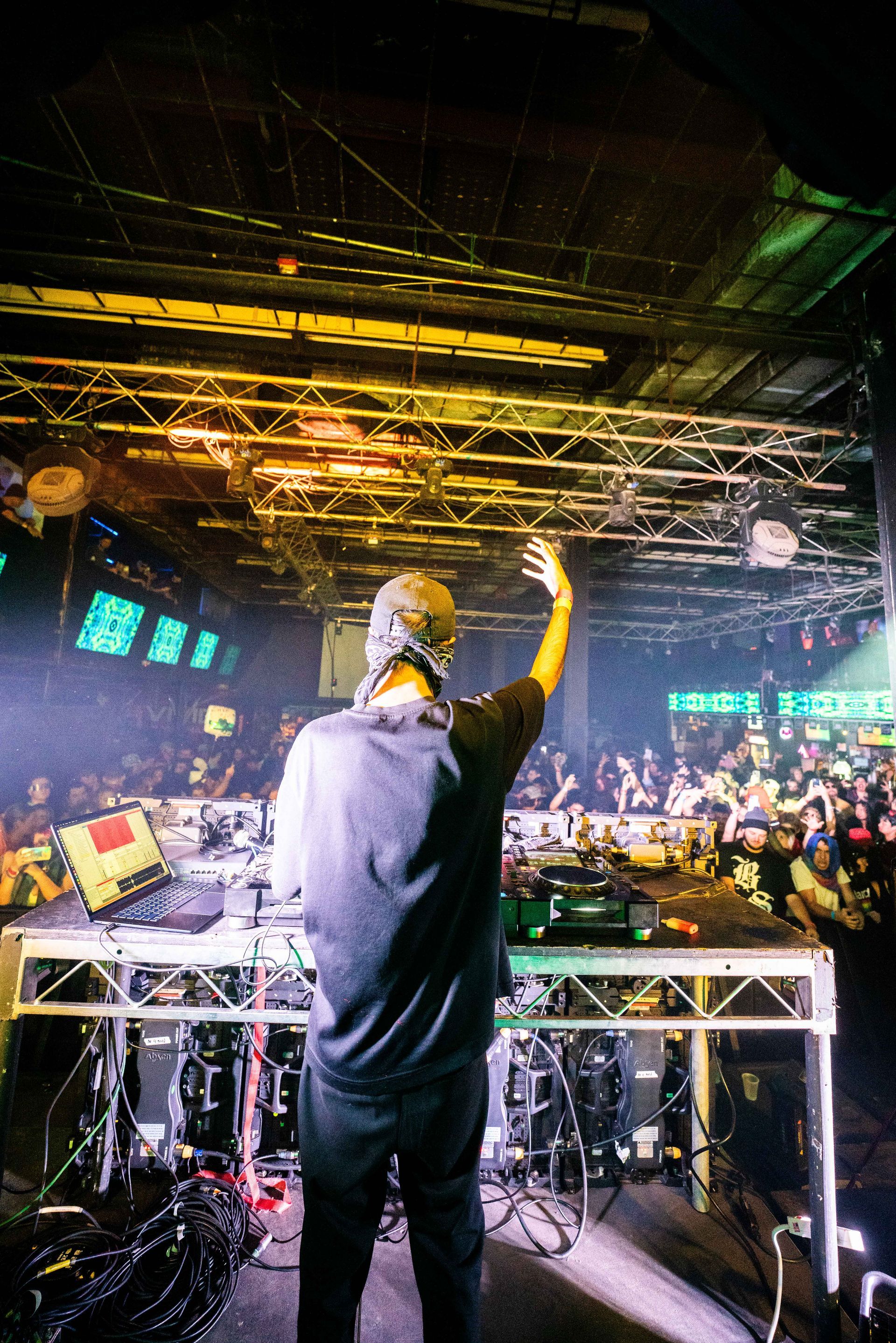 A man is standing on a stage in front of a crowd.