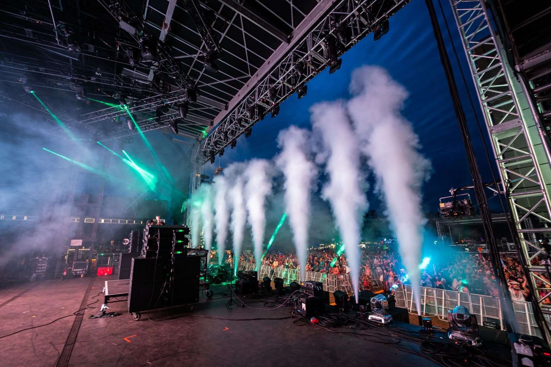 A stage with smoke coming out of it at a concert.