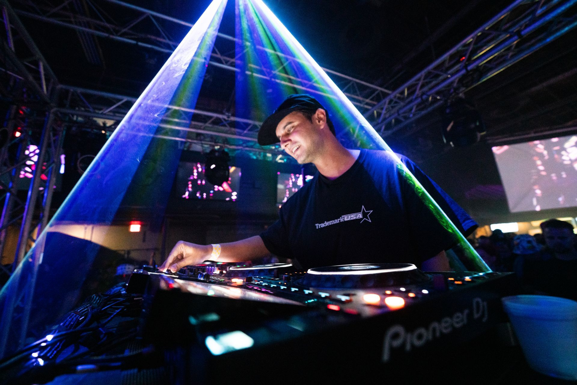 A man is playing music on a pioneer dj turntable