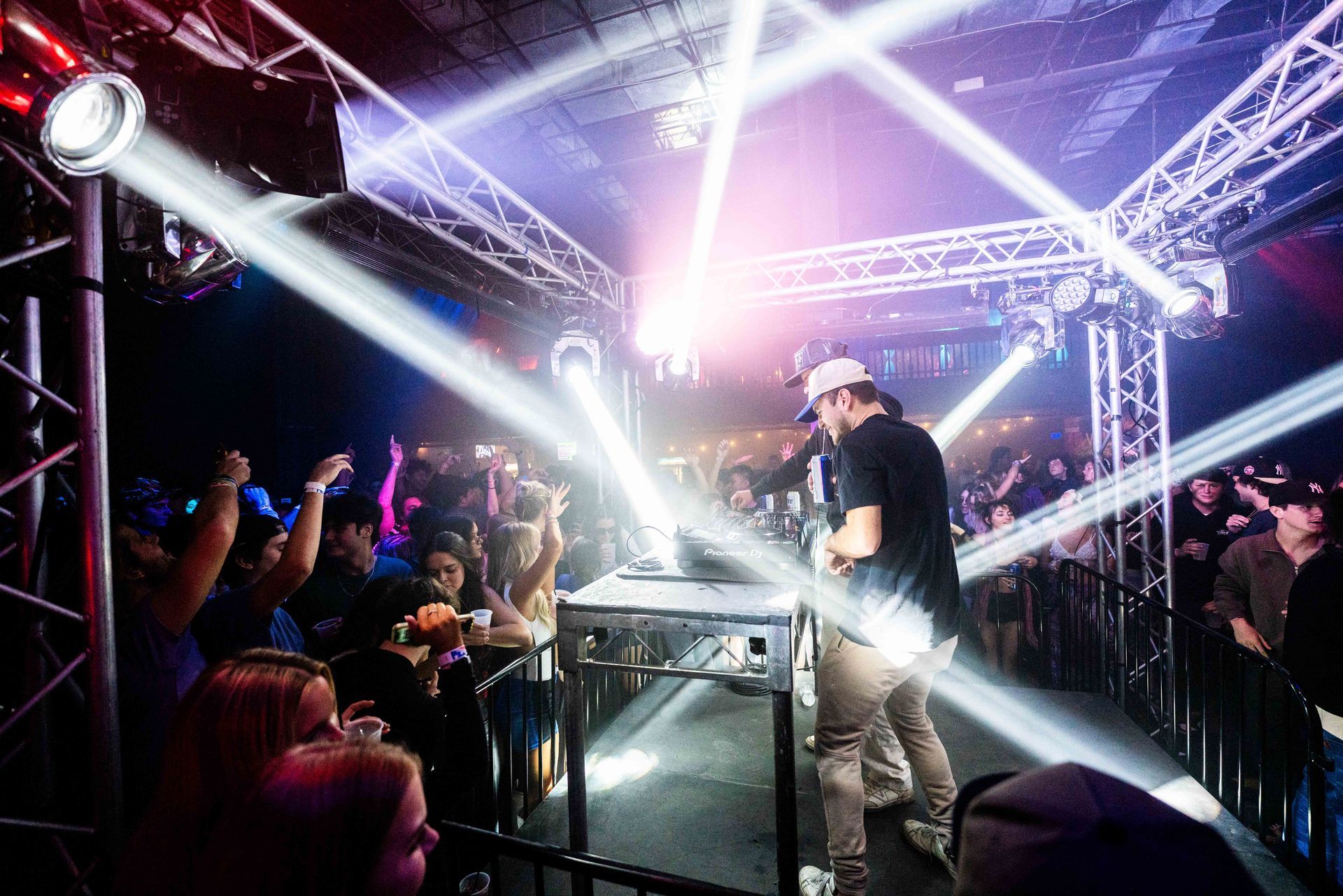A man is standing on a stage in front of a crowd at a concert.