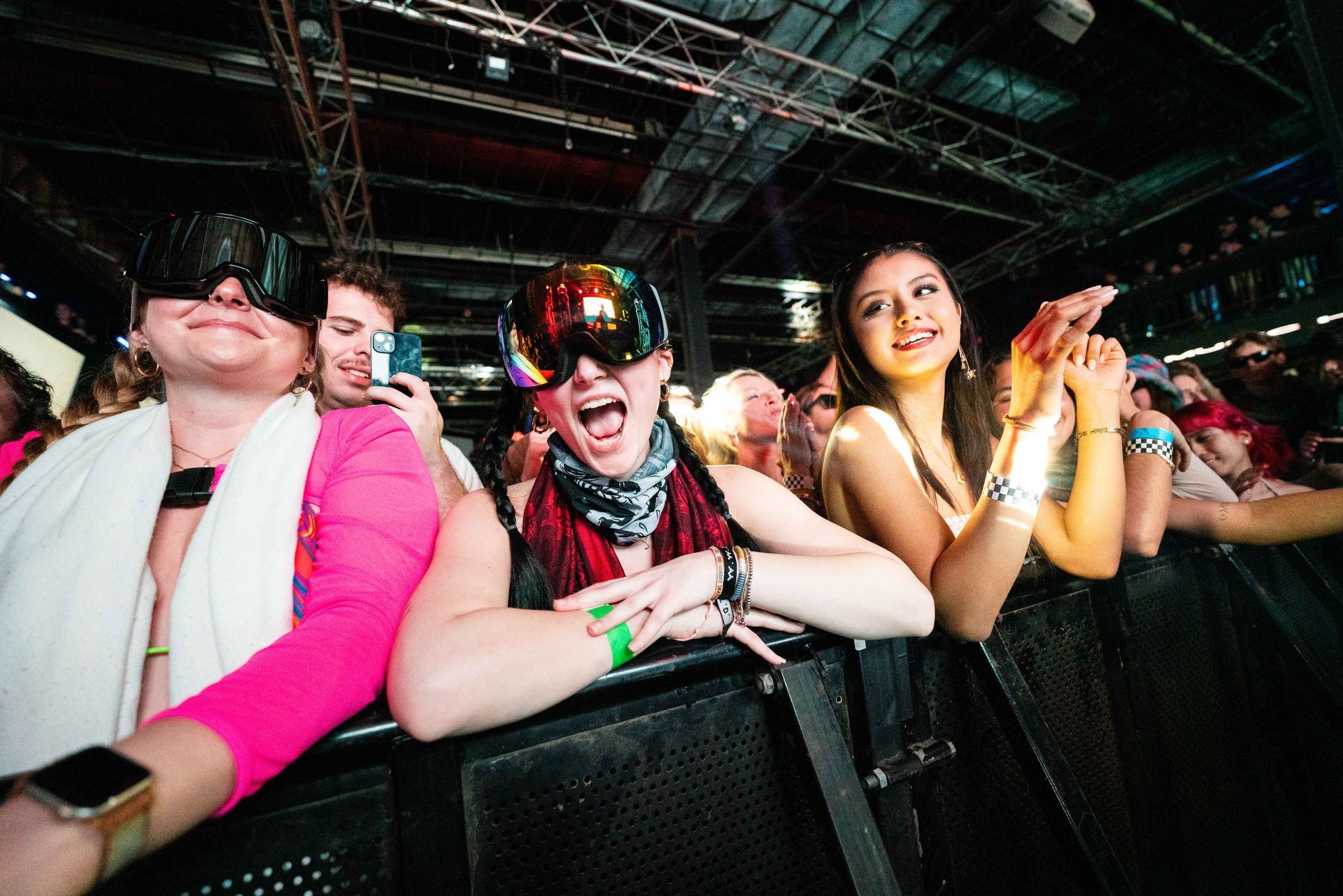 A group of people are sitting in a row at a concert.
