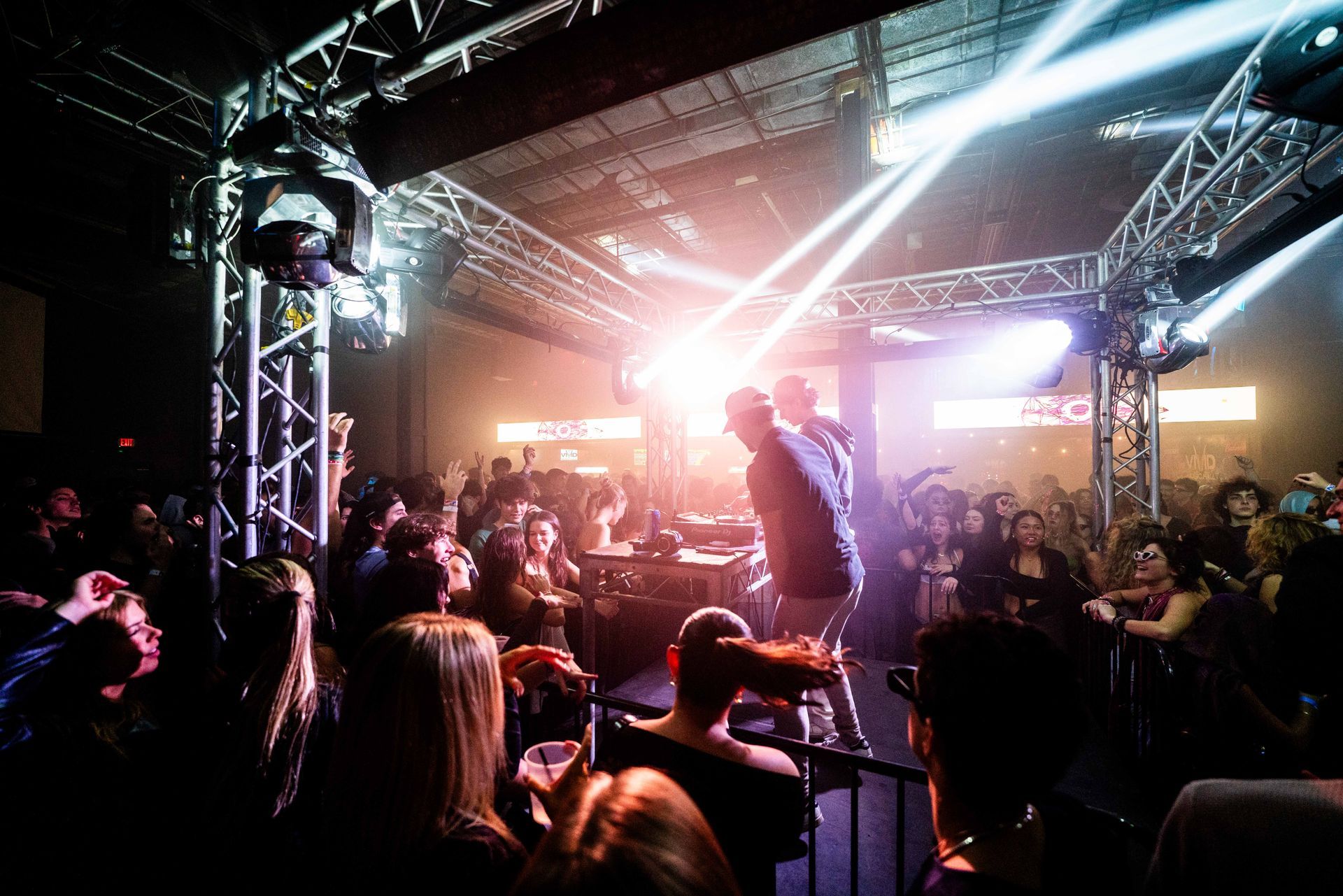 A man is singing into a microphone in front of a crowd at a concert.