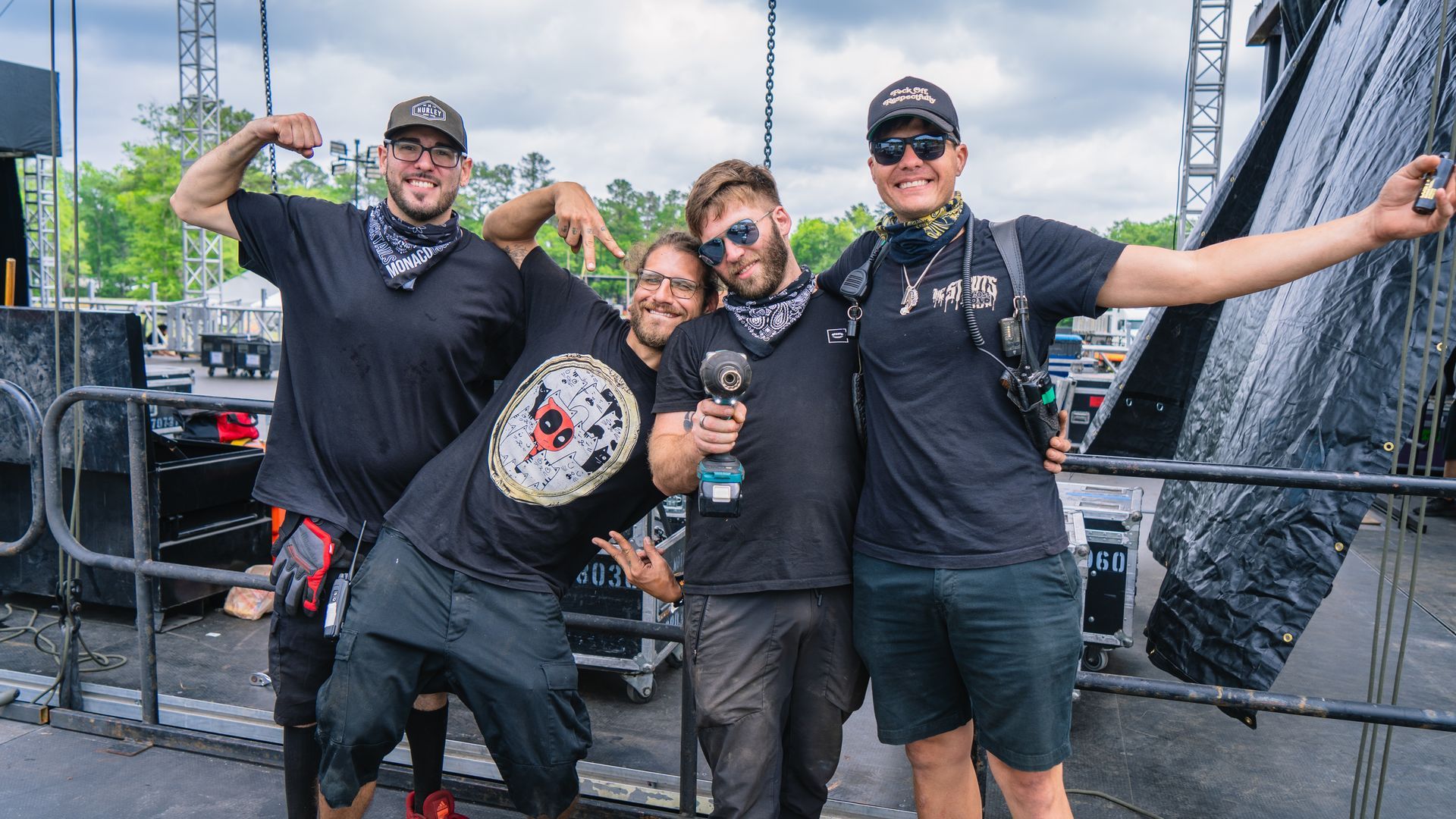 A group of men are posing for a picture in front of a stage.
