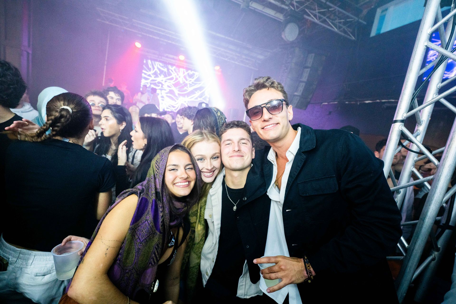 A group of people are posing for a picture at a party.