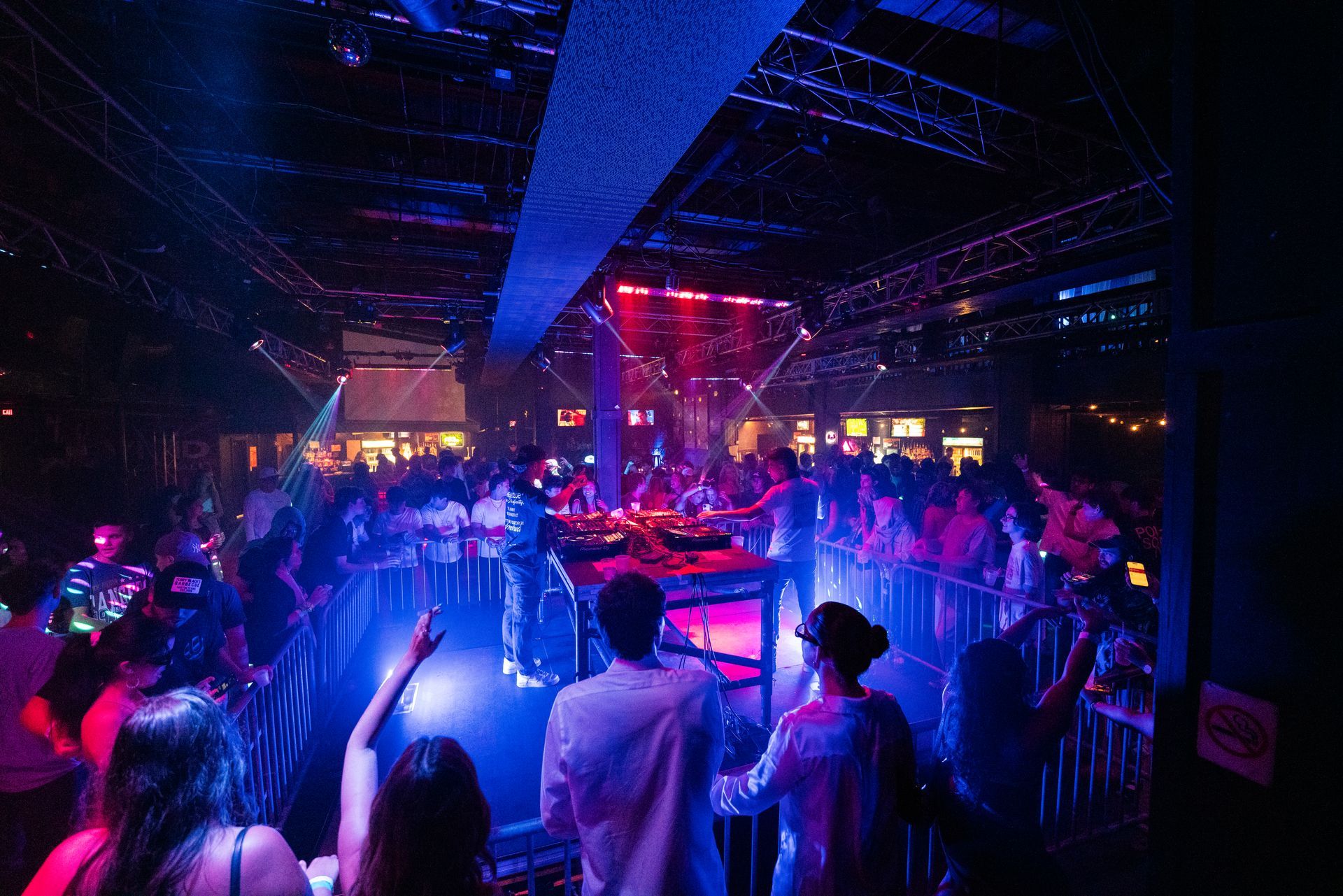 A crowd of people are dancing in a nightclub.