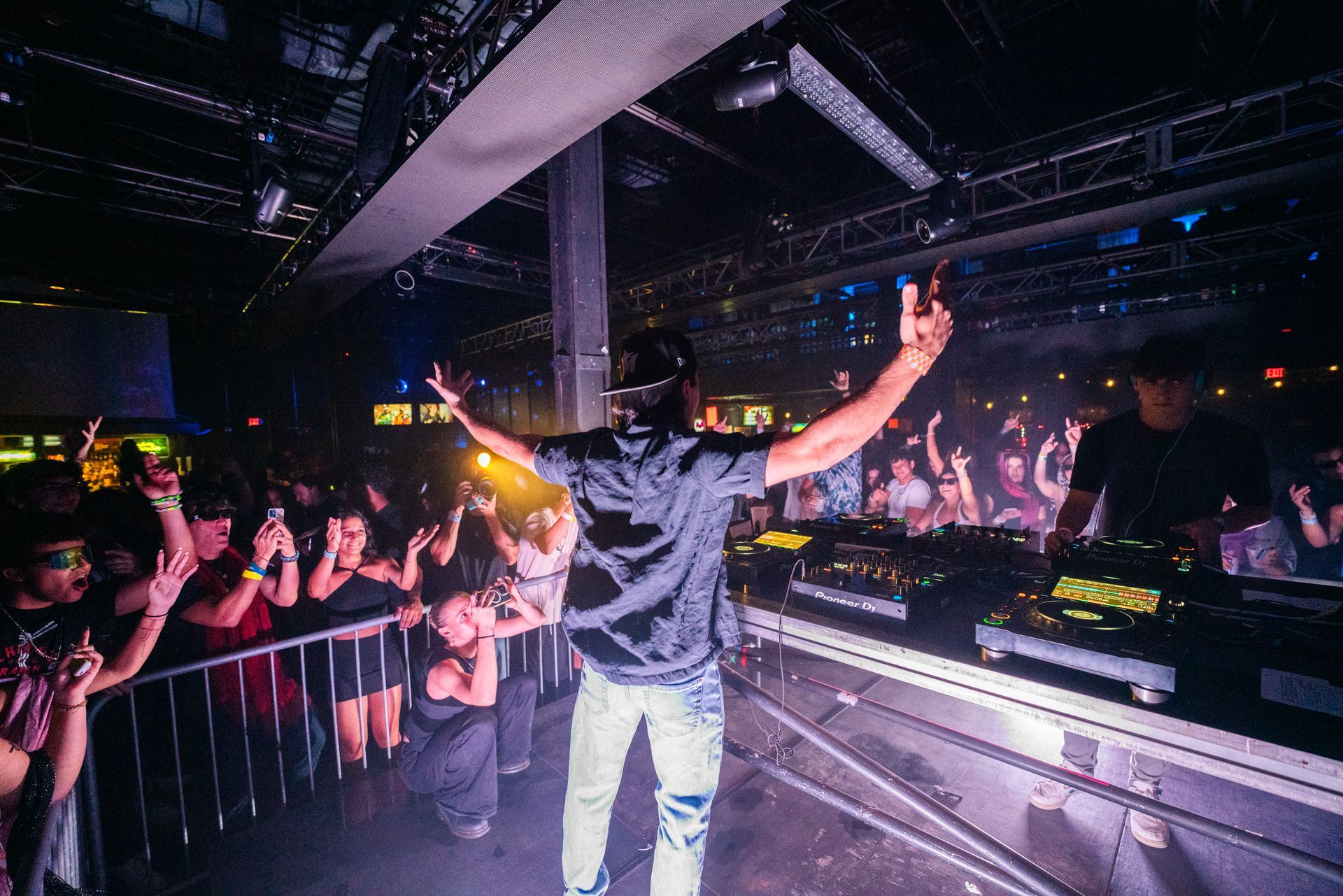 A man is standing on a stage in front of a crowd of people.