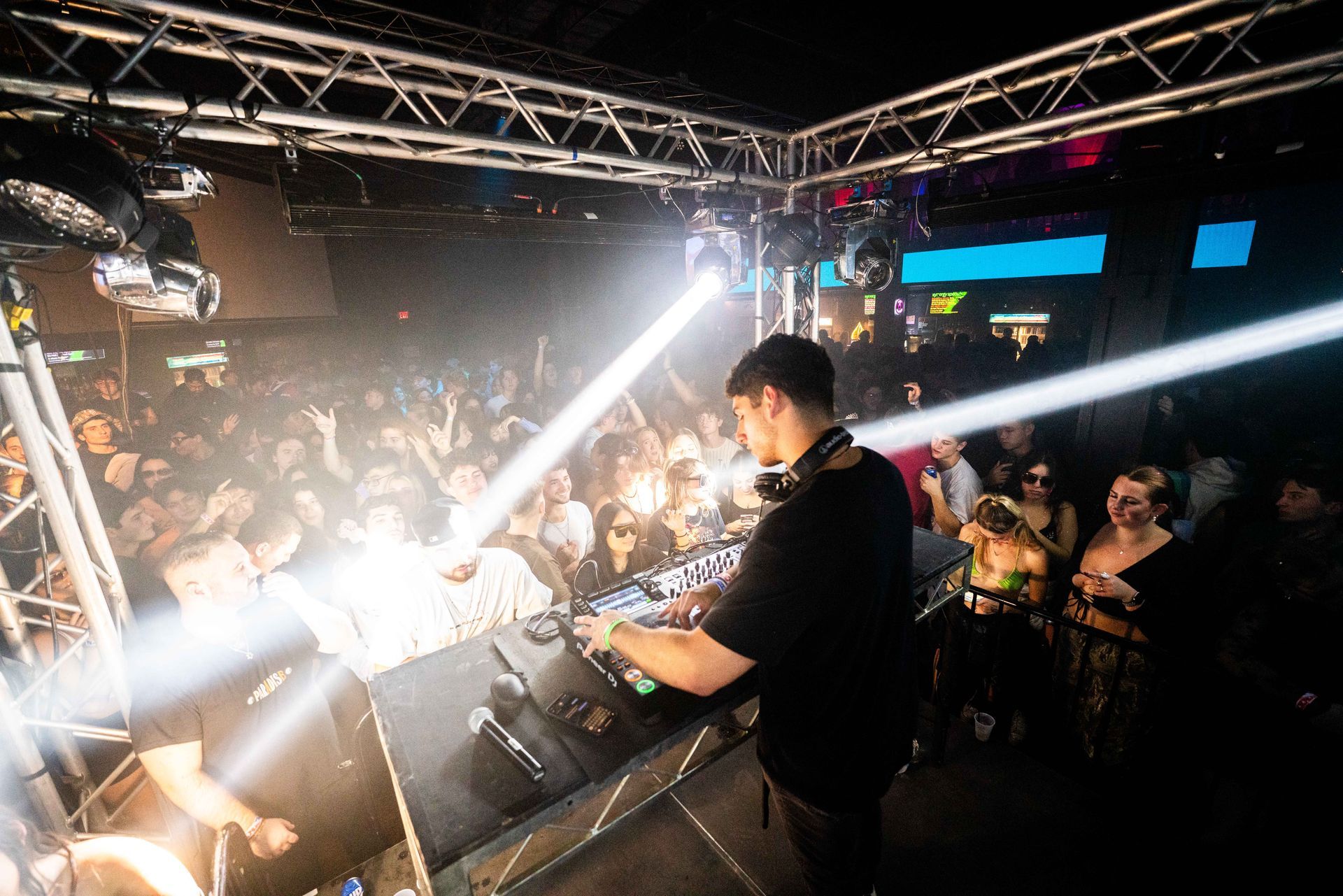 A man is playing music on a stage in front of a crowd.