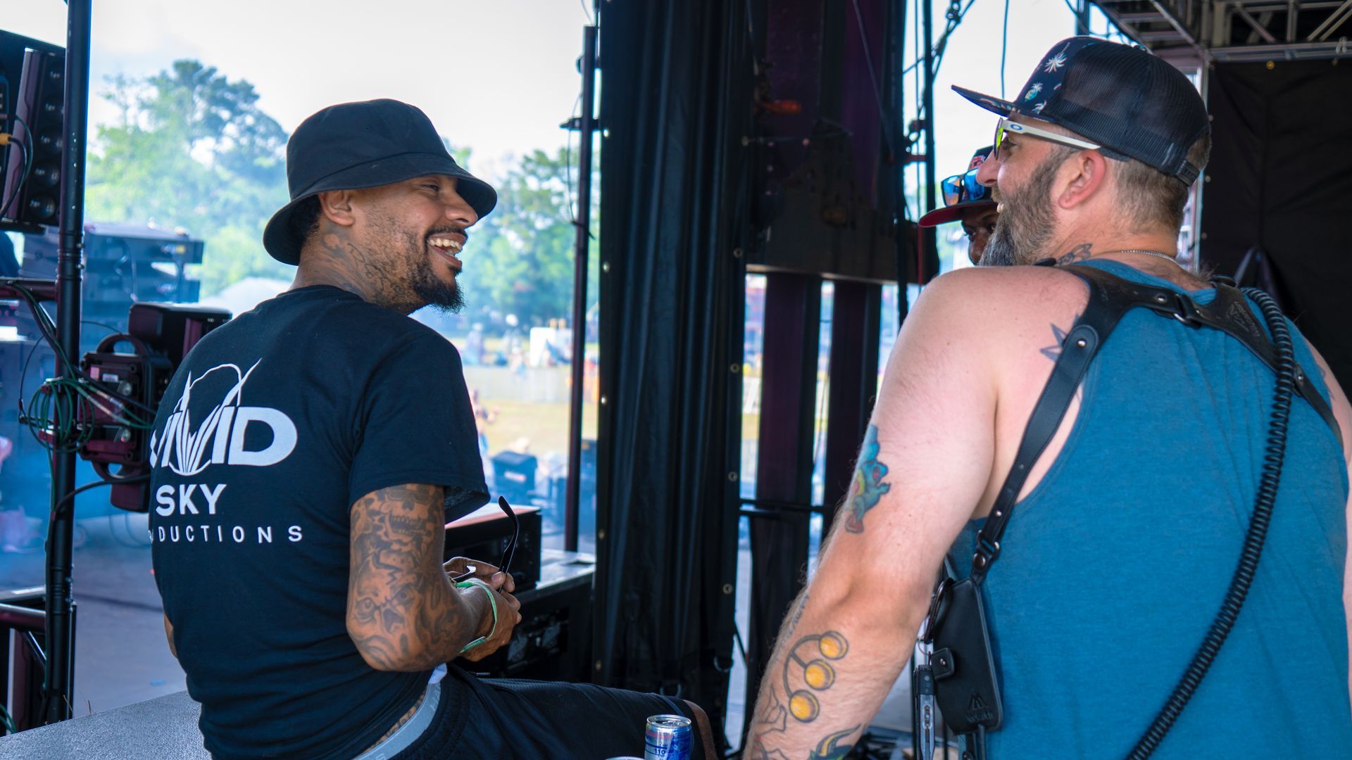Two men are sitting next to each other in front of a microphone.