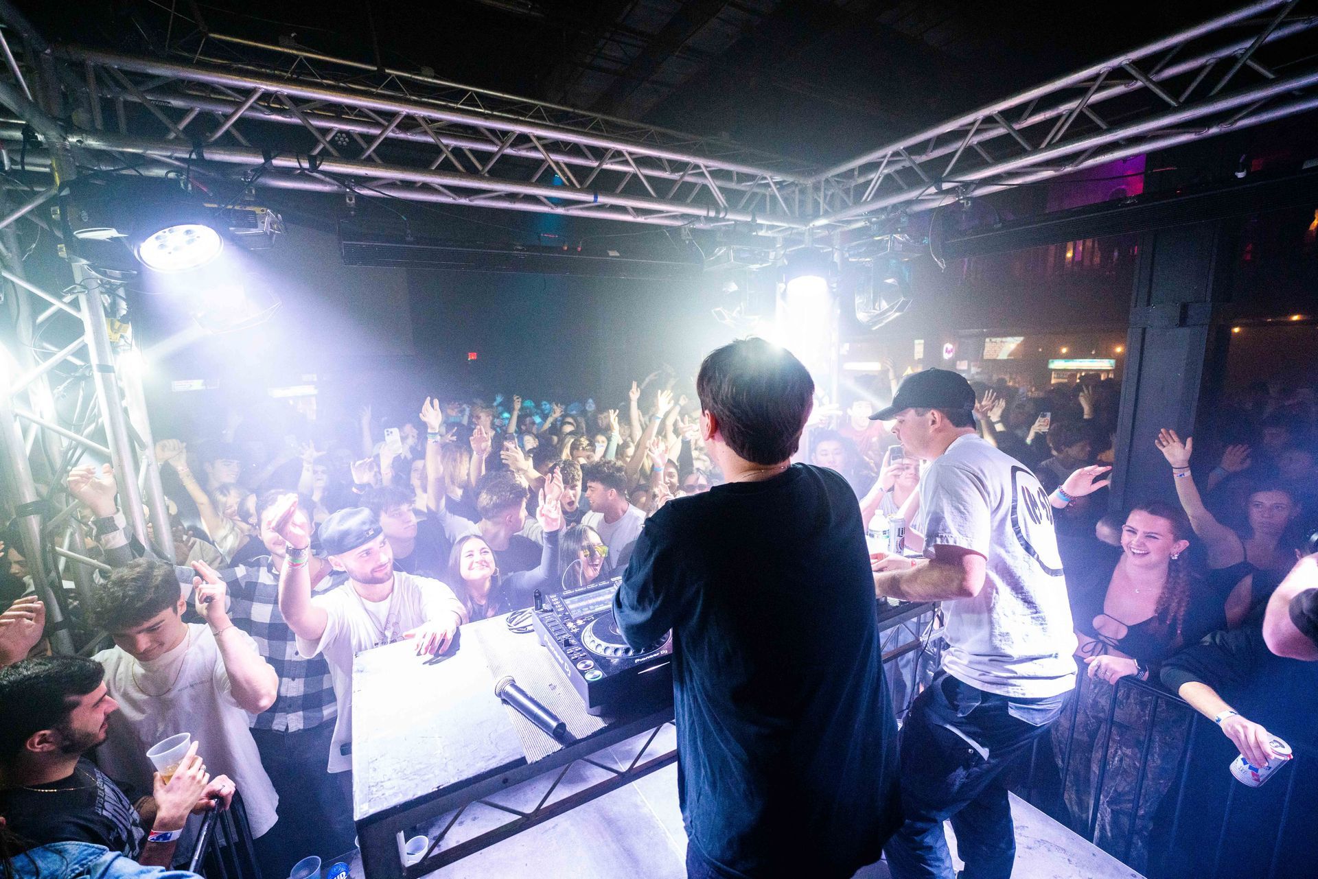 A group of people are standing on a stage in front of a crowd.