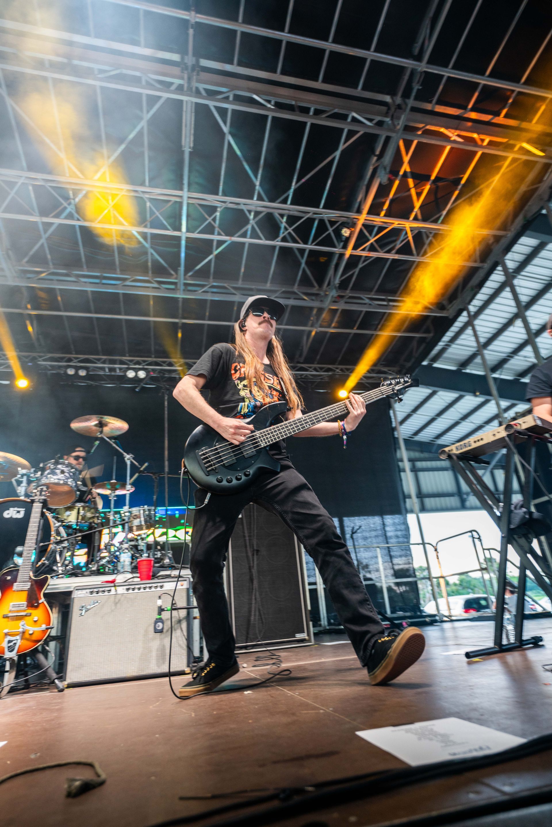 A man is playing a guitar on stage at a concert.