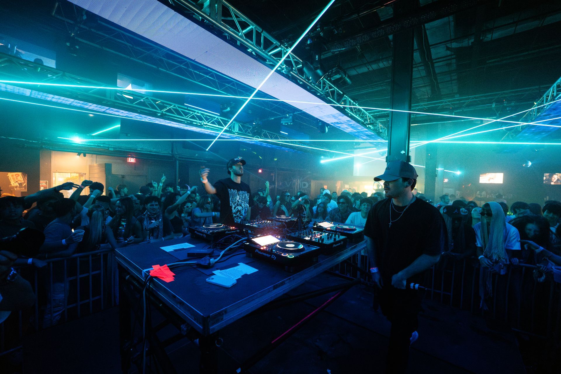 Two men are playing music at a concert in front of a crowd.