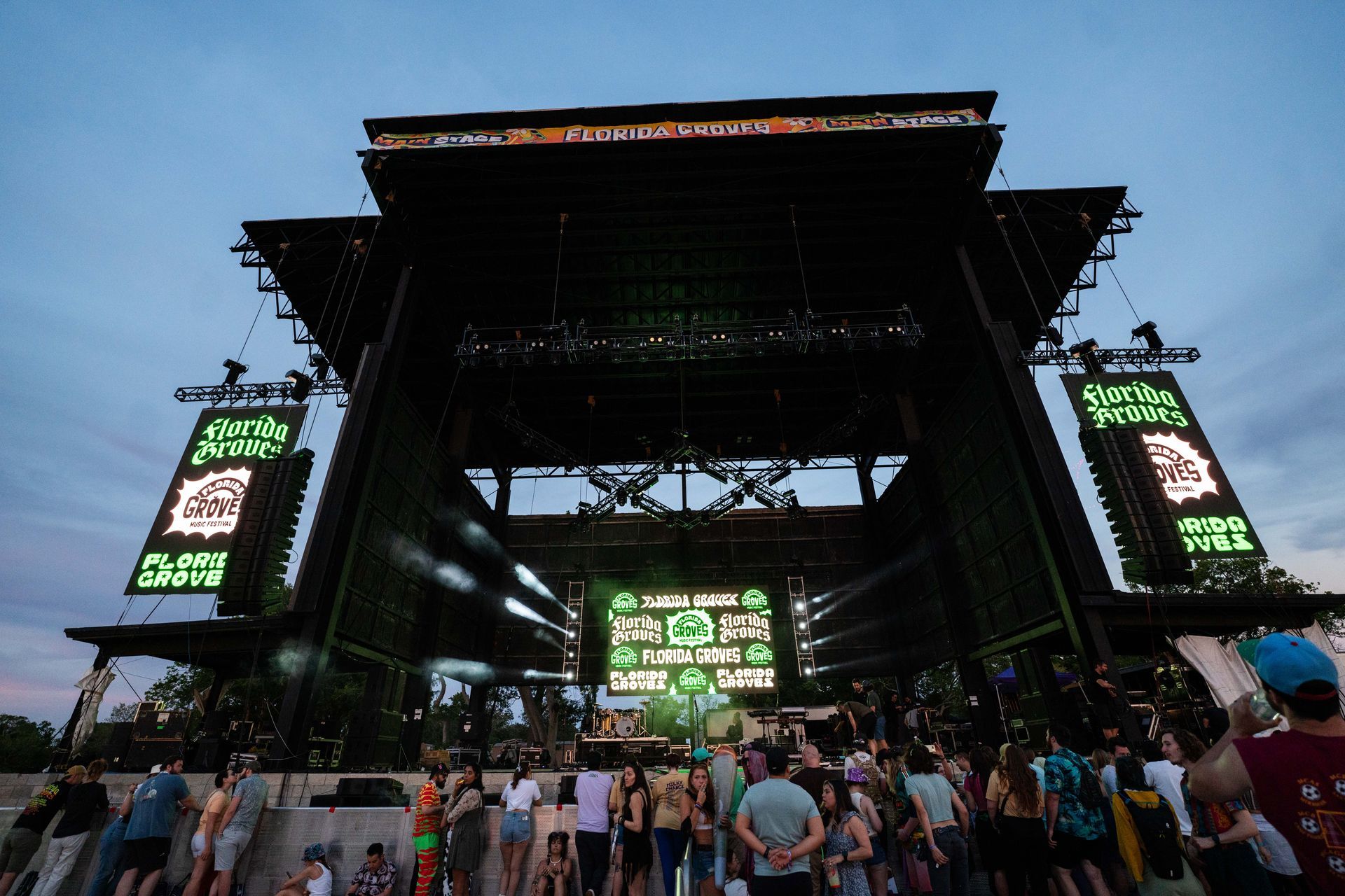A group of people are standing in front of a large stage.
