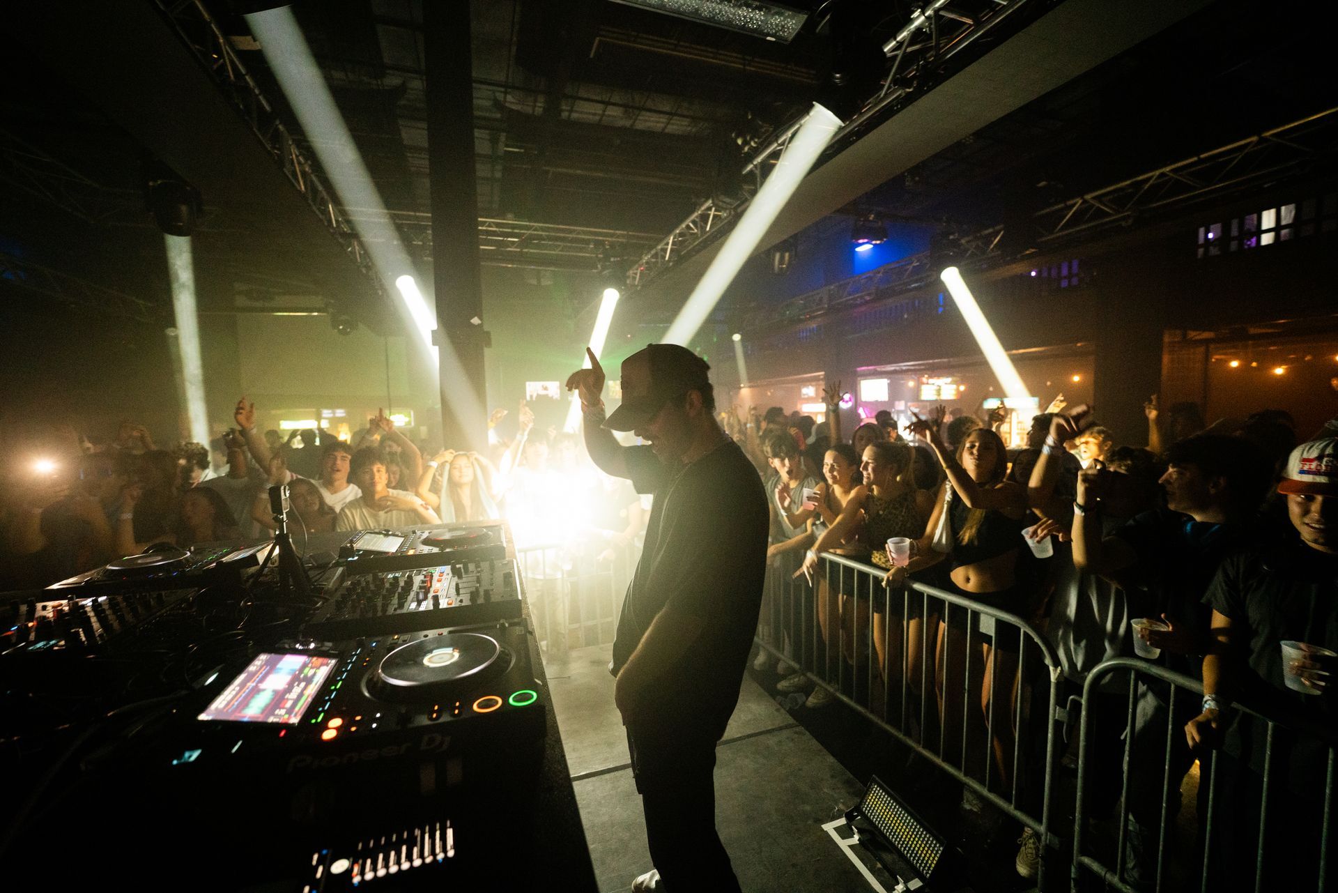 A dj is playing music in front of a crowd at a concert.