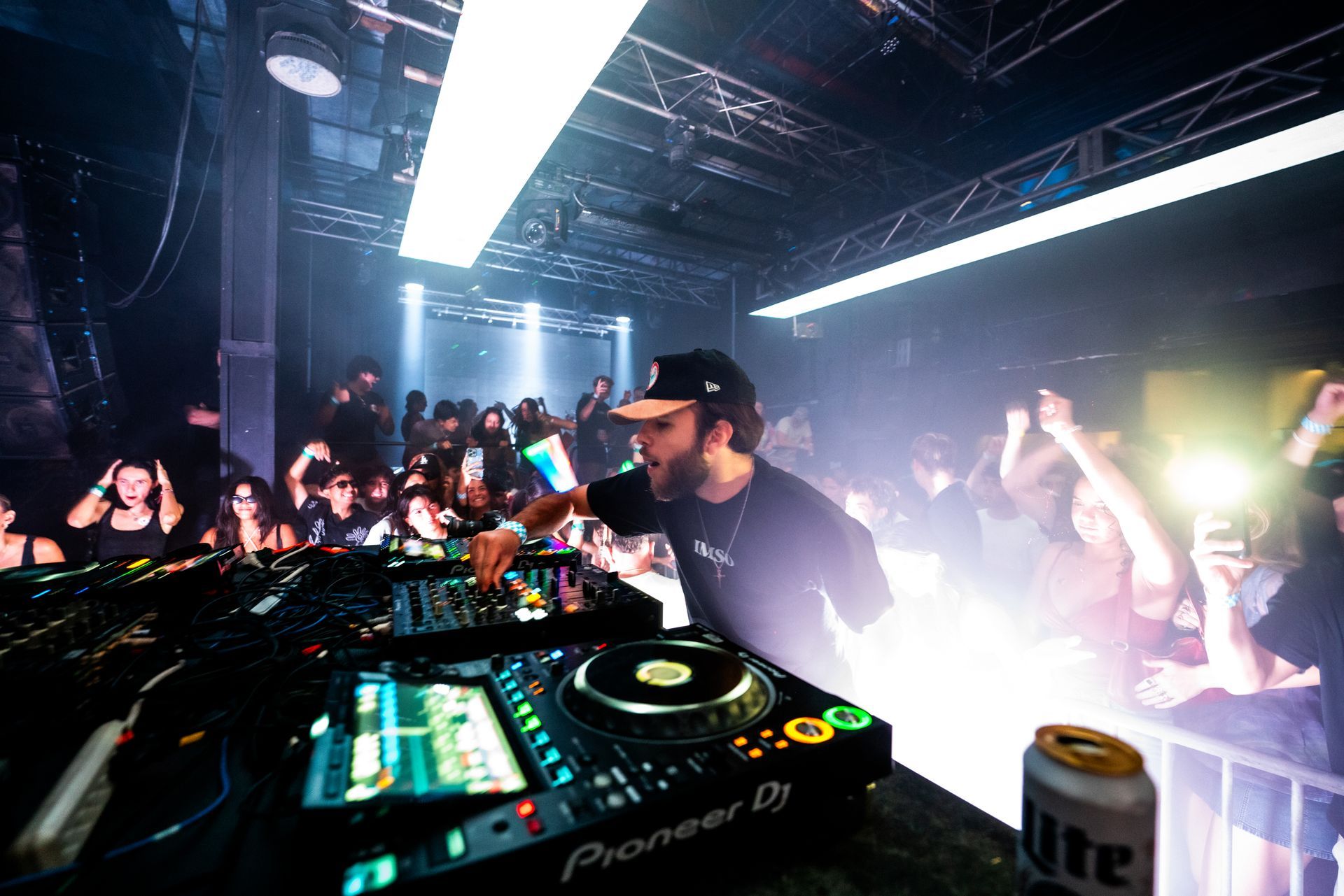 A dj is playing music in front of a crowd at a party.