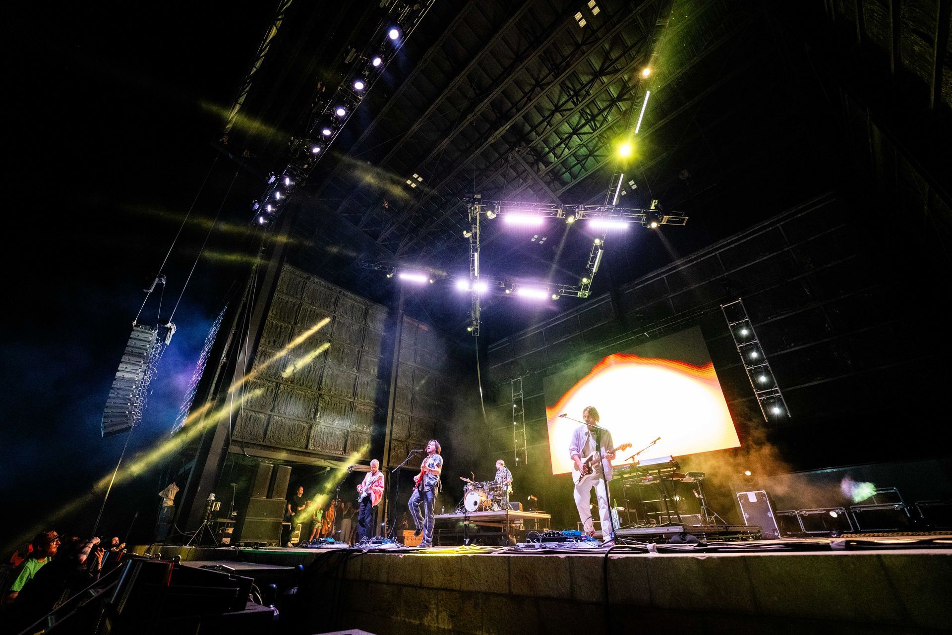 A group of people are playing instruments on a stage at a concert.