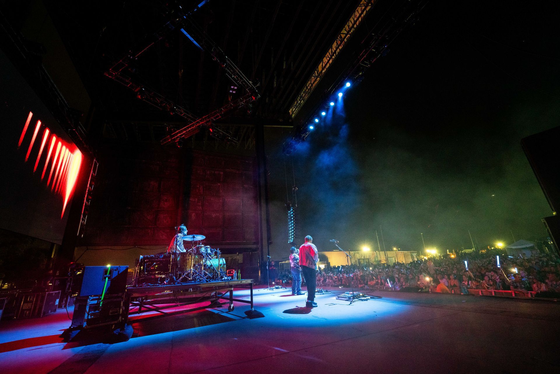 A man is playing a guitar on a stage in front of a crowd.