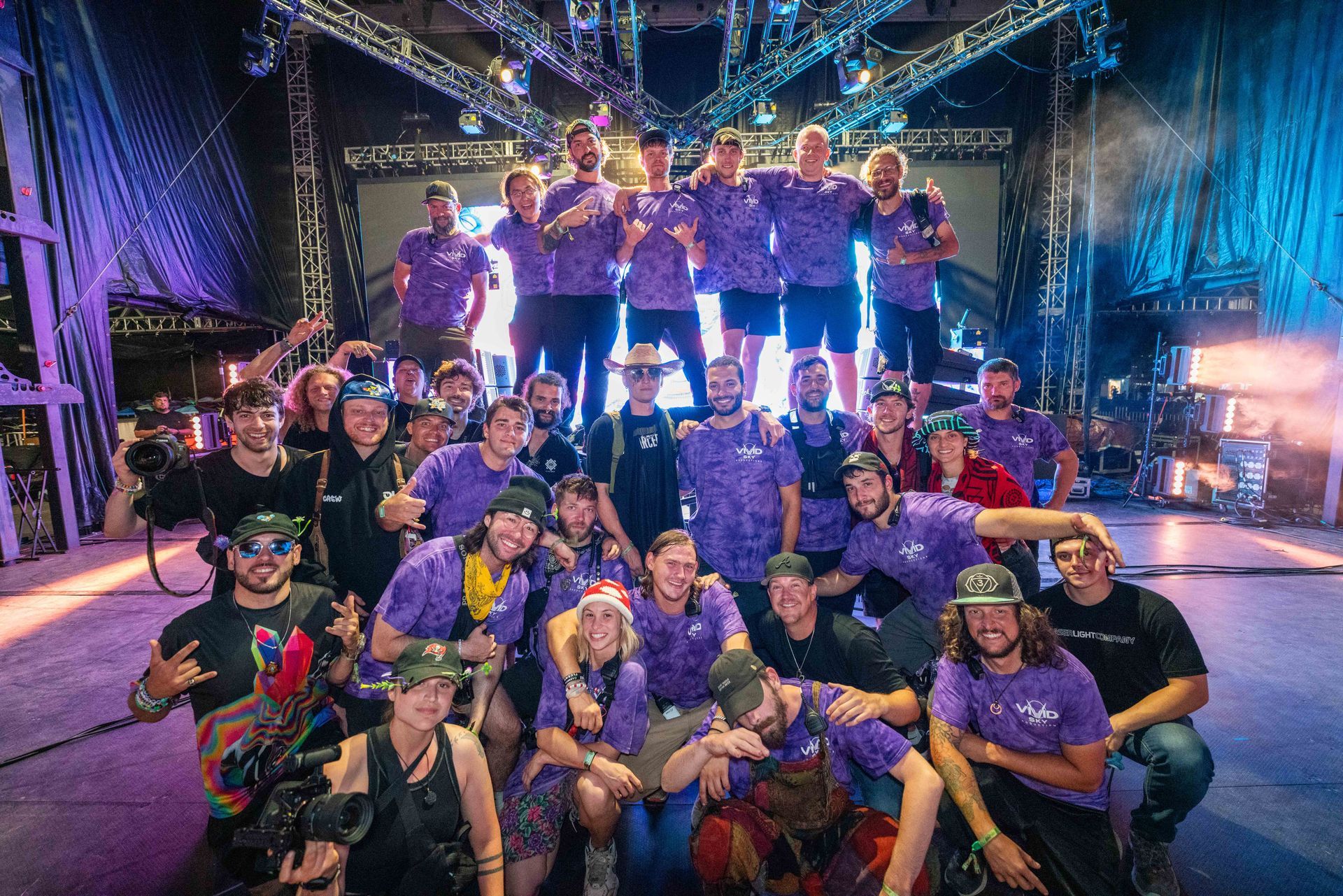 A group of people are posing for a picture on a stage.