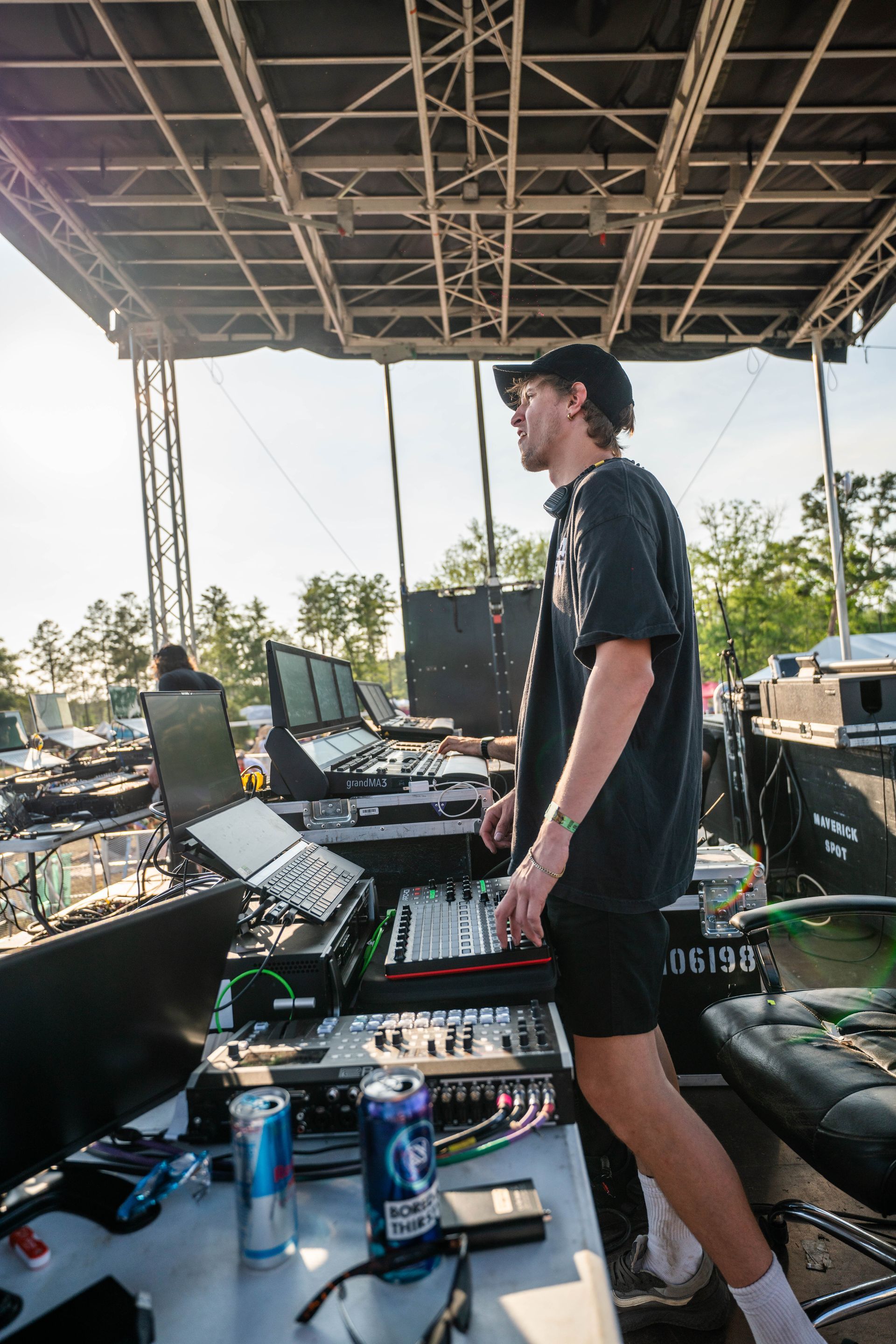 A man is standing at a desk in front of a stage.