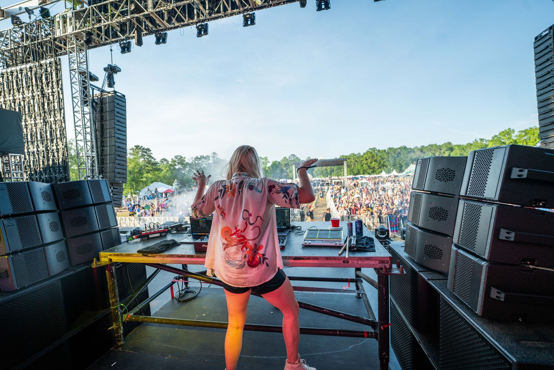 A woman is standing on a stage in front of a crowd.
