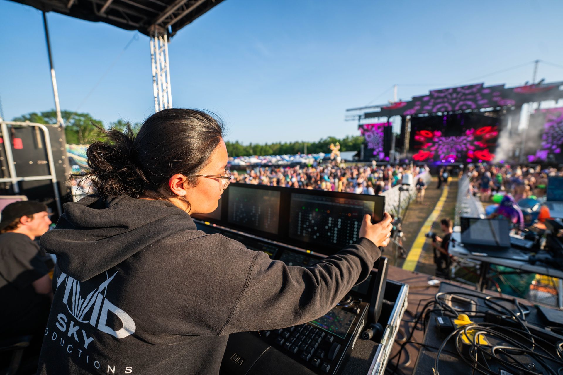 A woman is taking a picture of a crowd at a concert.
