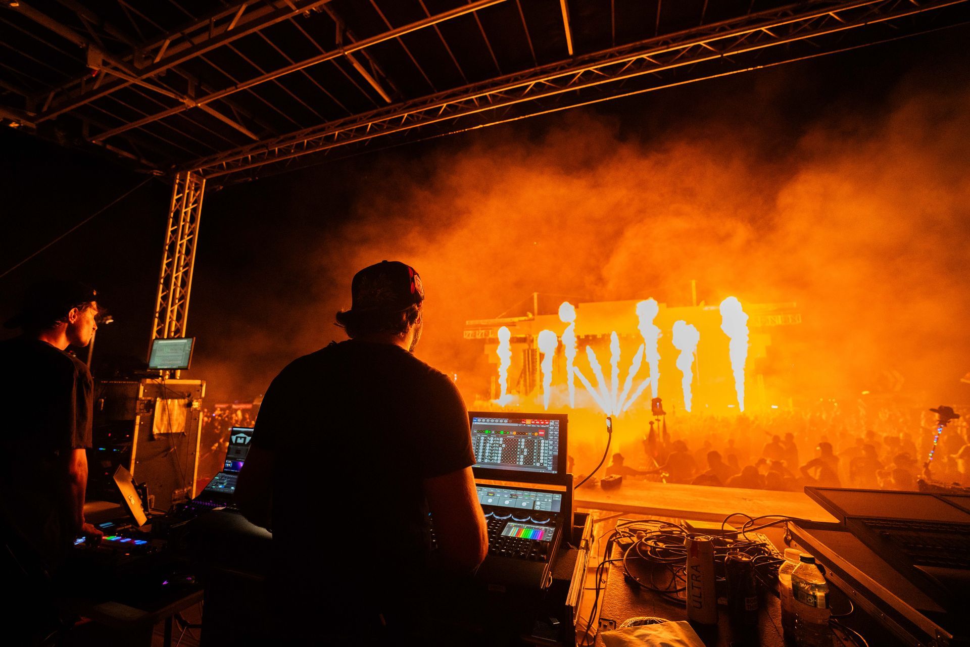 A dj is playing music on a stage at a concert.