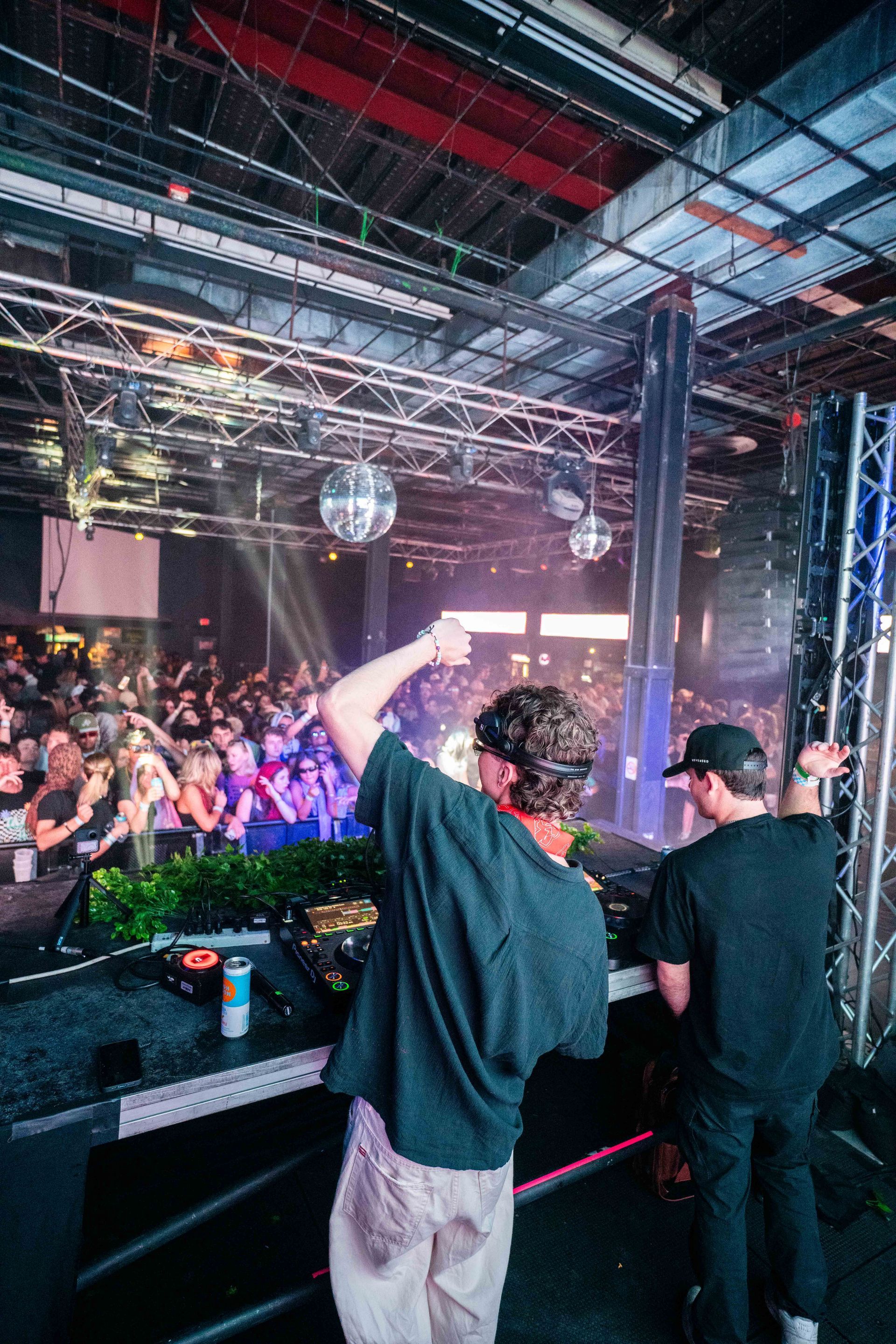 Two men are standing in front of a crowd at a concert.