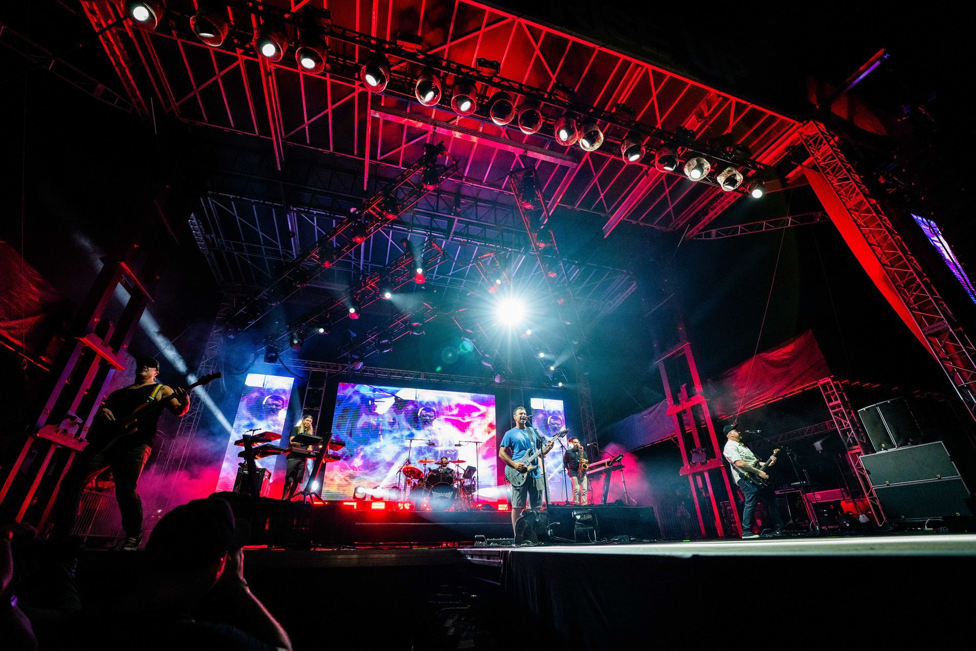 A group of people are playing instruments on a stage at a concert.
