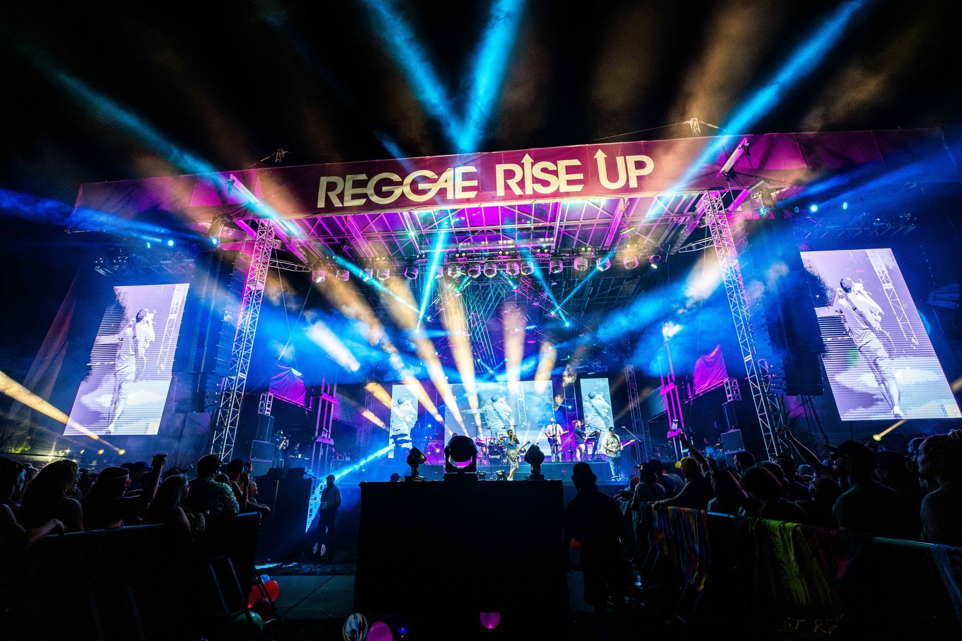 A stage with a sign that says reggae rise up