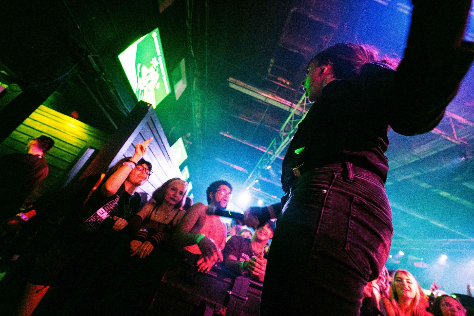 A man singing into a microphone in front of a crowd of people