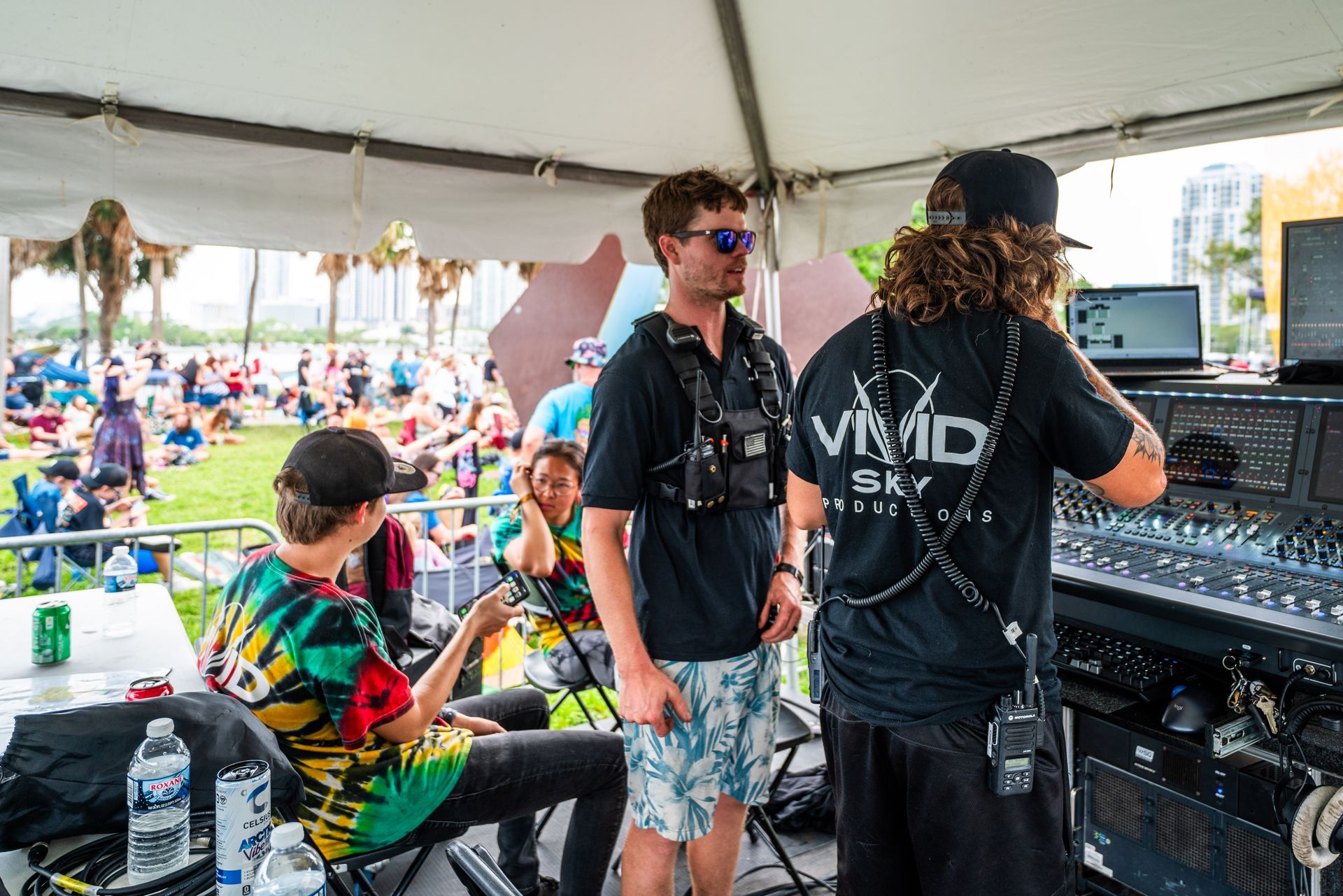 A group of people are standing under a tent.