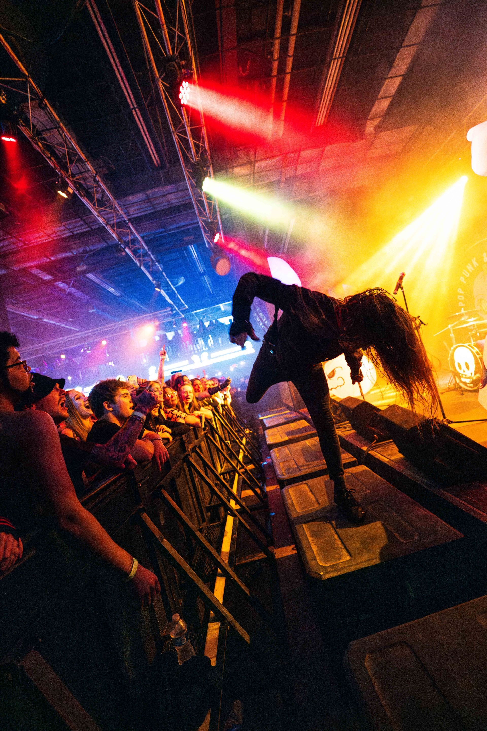 A crowd of people watching a band perform on stage