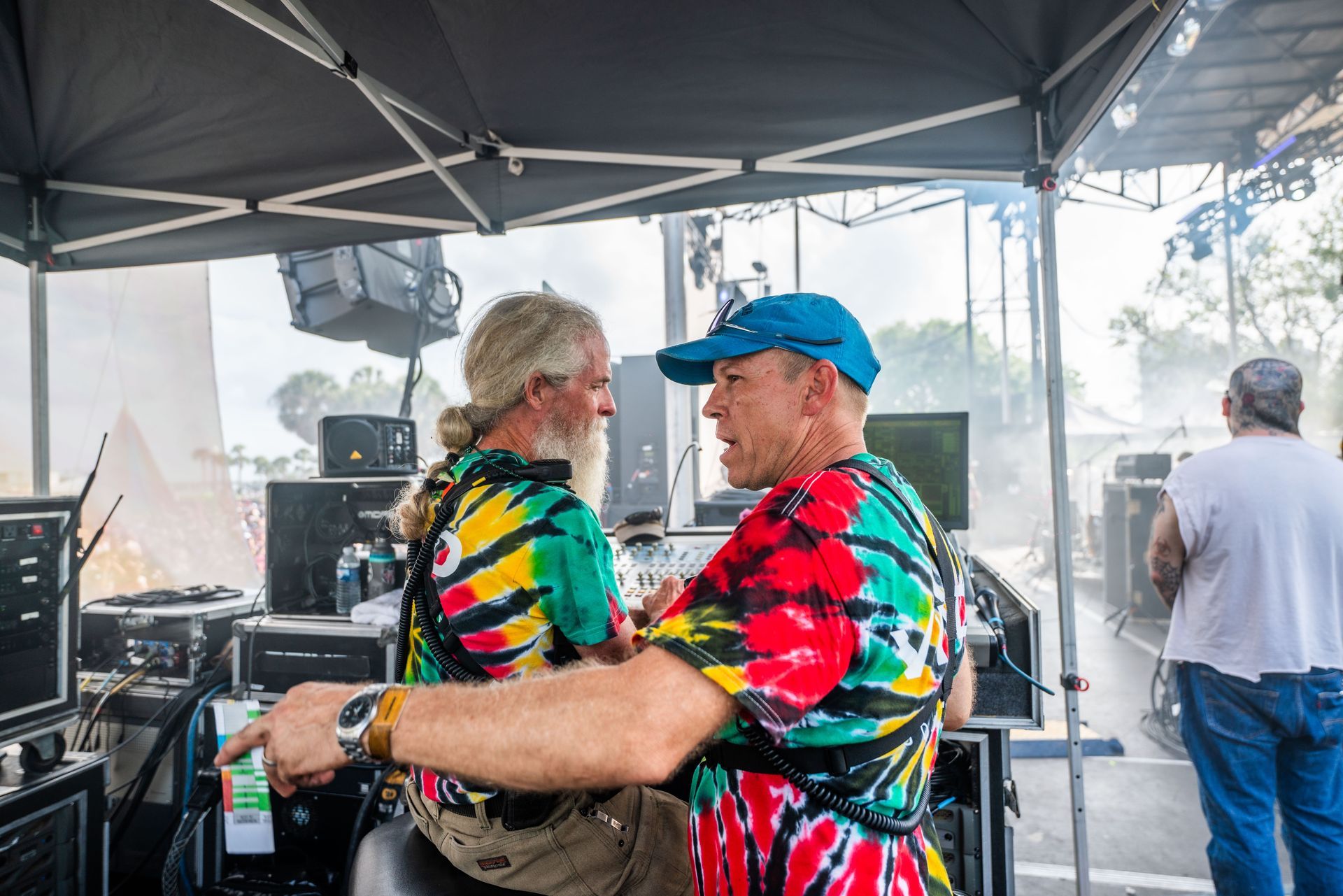 Two men are hugging each other under a tent.