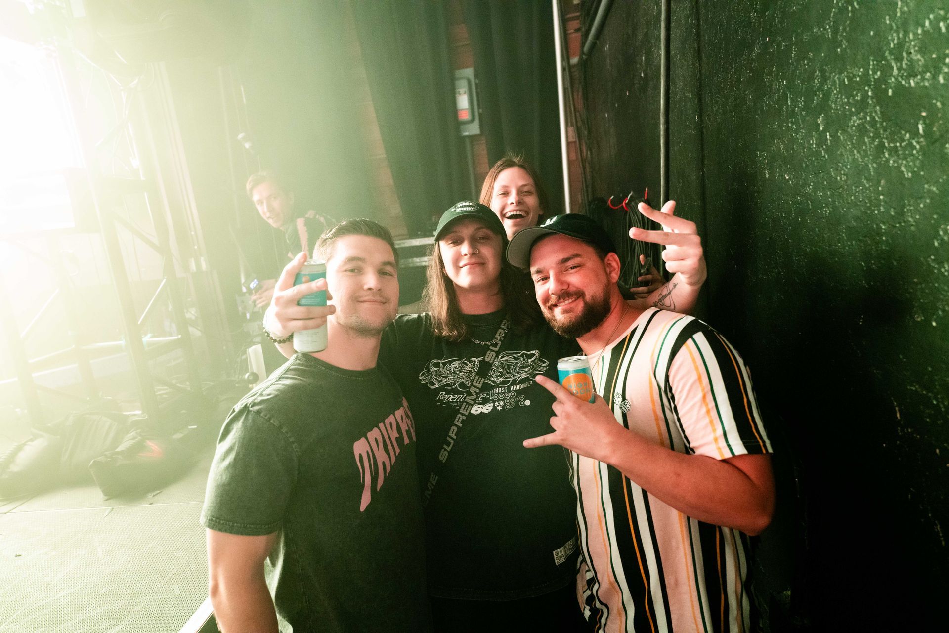 A group of people are posing for a picture in a dark room.