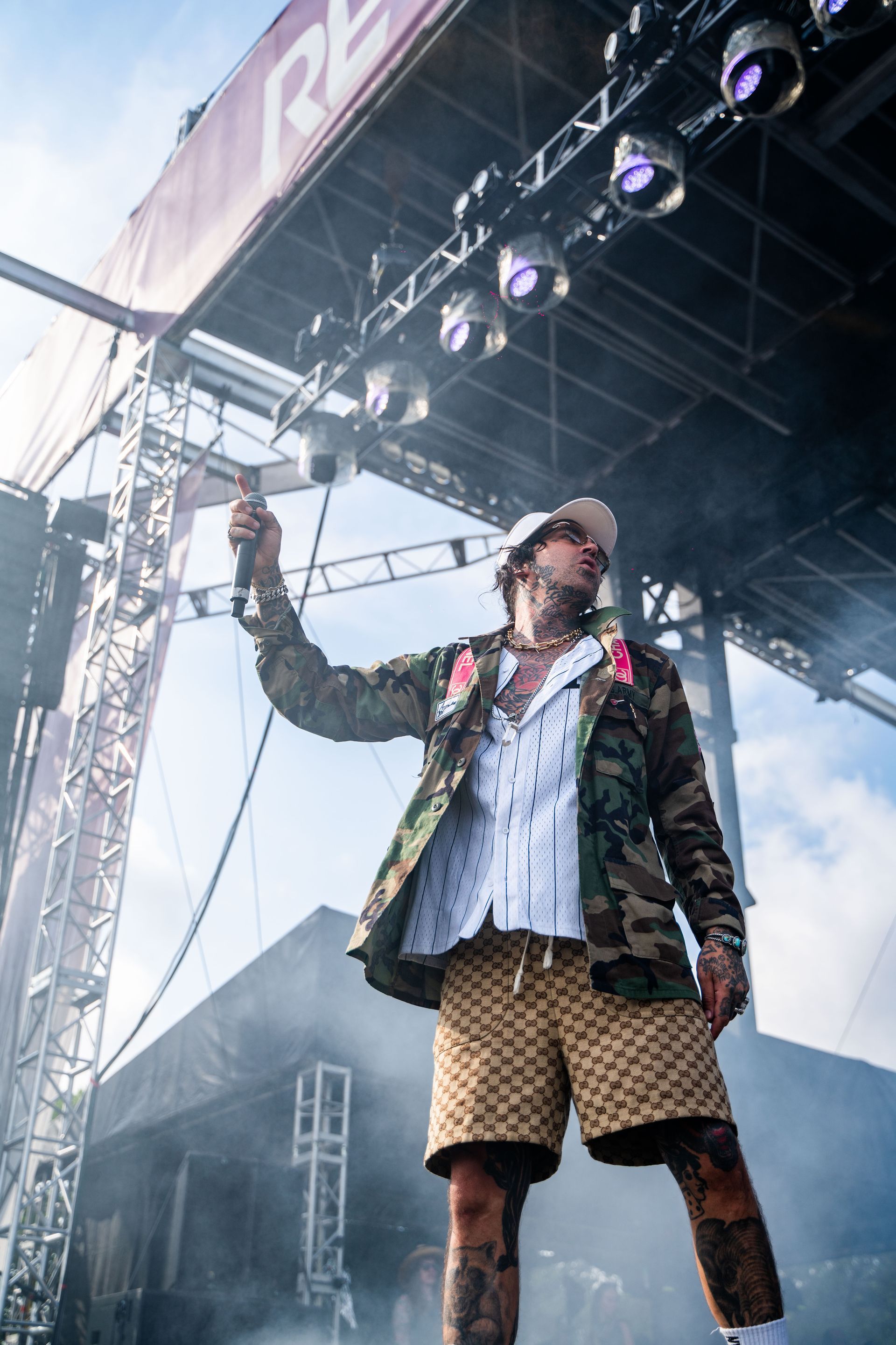 A man is standing on a stage holding a microphone.