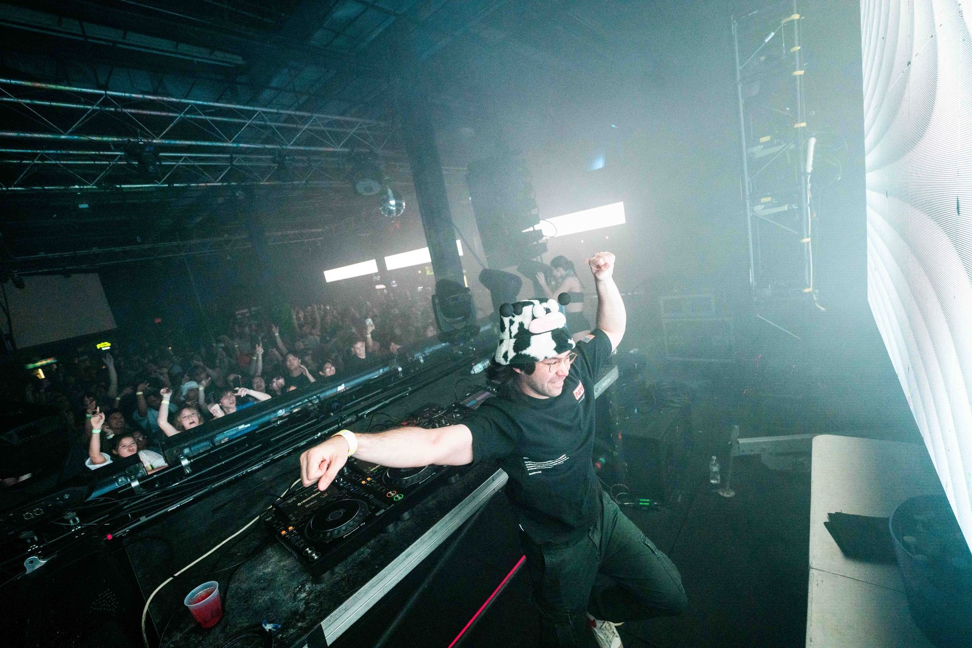 A man is dancing on a stage in front of a crowd.