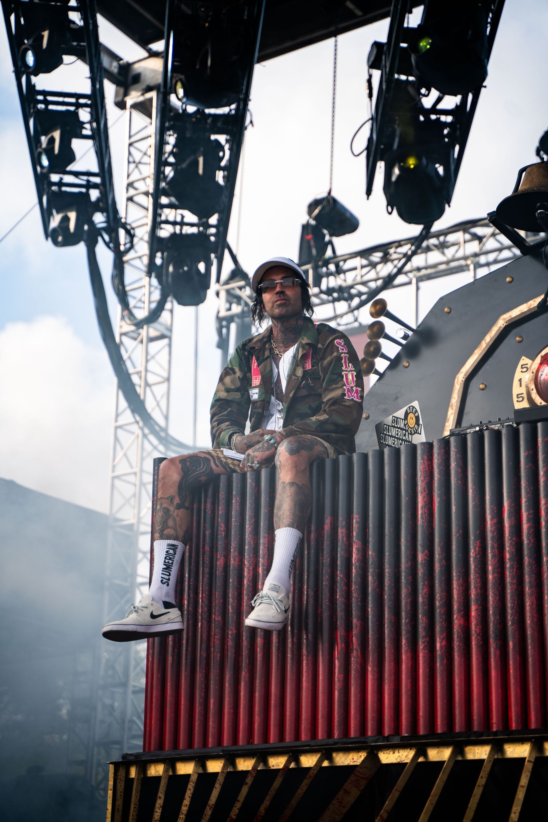 A man is sitting on top of a stage holding a microphone.