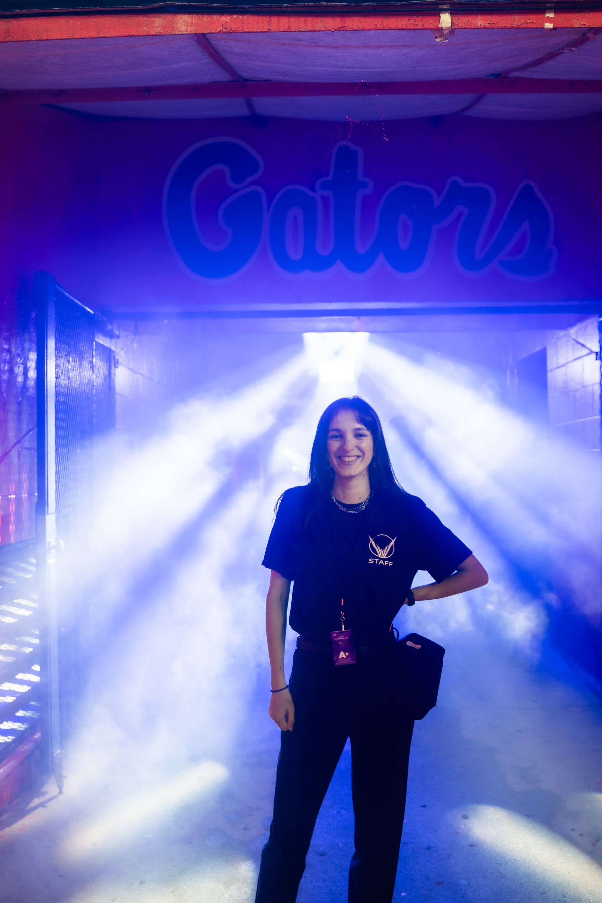 A woman is standing in front of a sign that says gators.