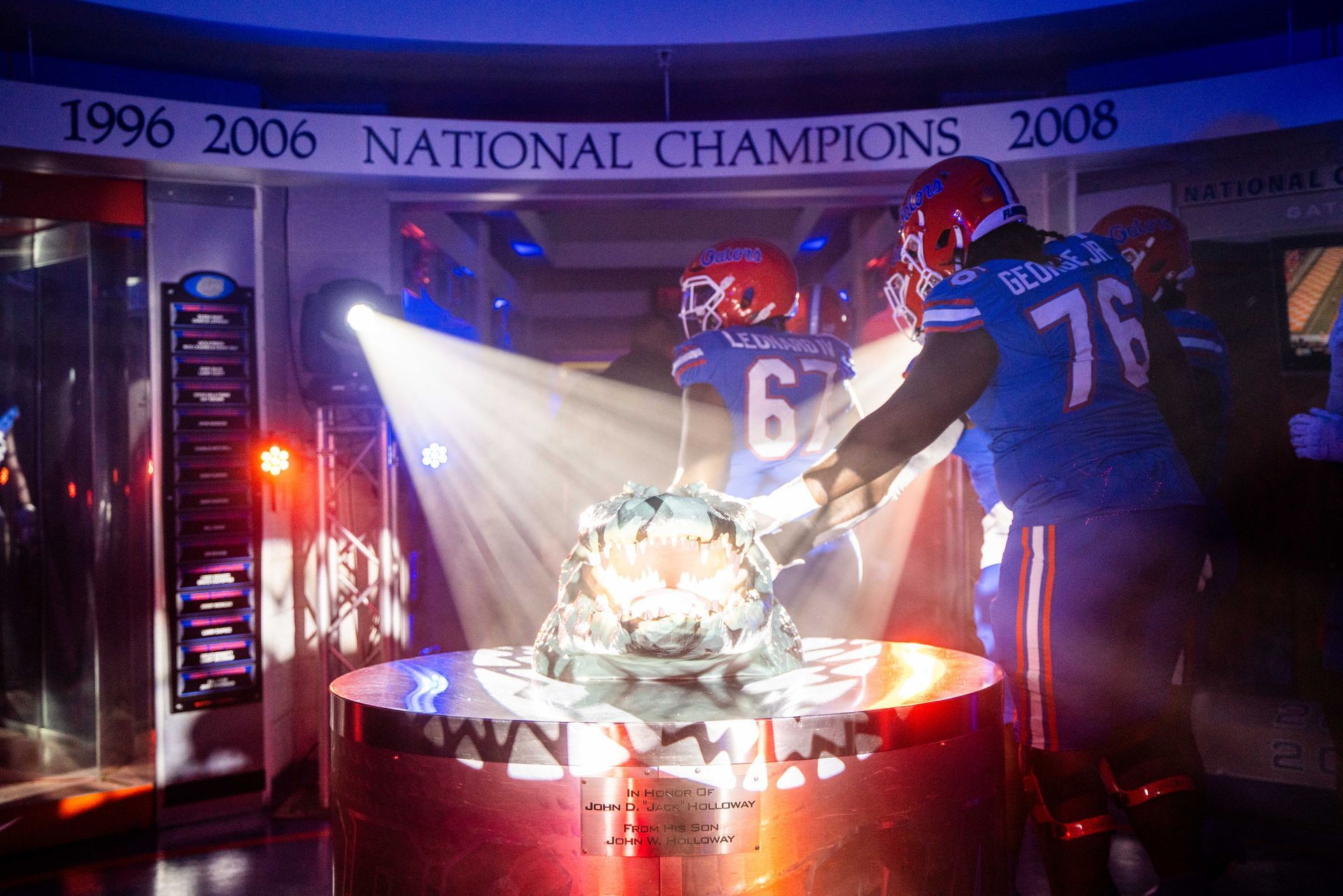 A group of football players are standing in front of a sign that says national champions