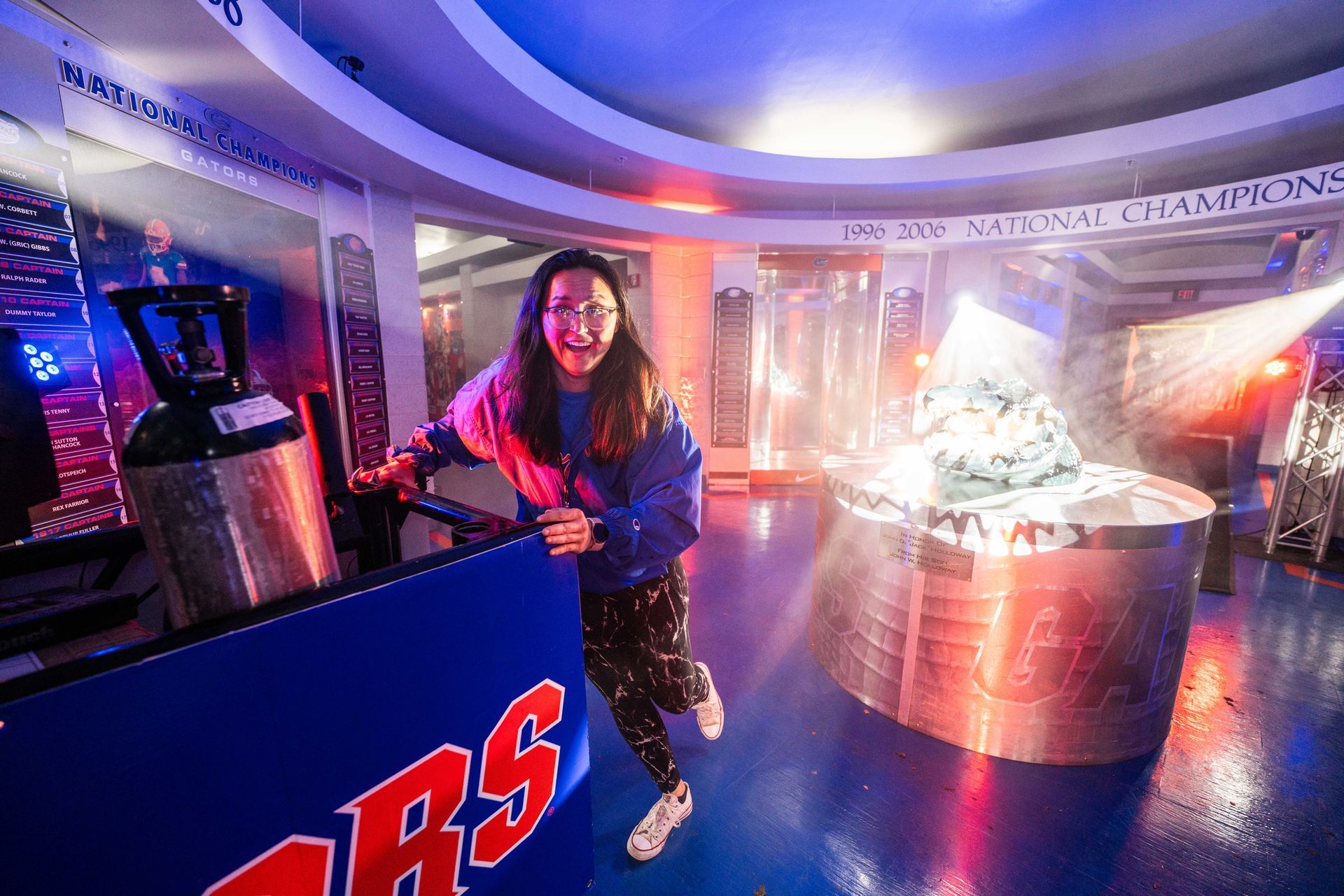 A woman is standing in a room with a sign that says rs.