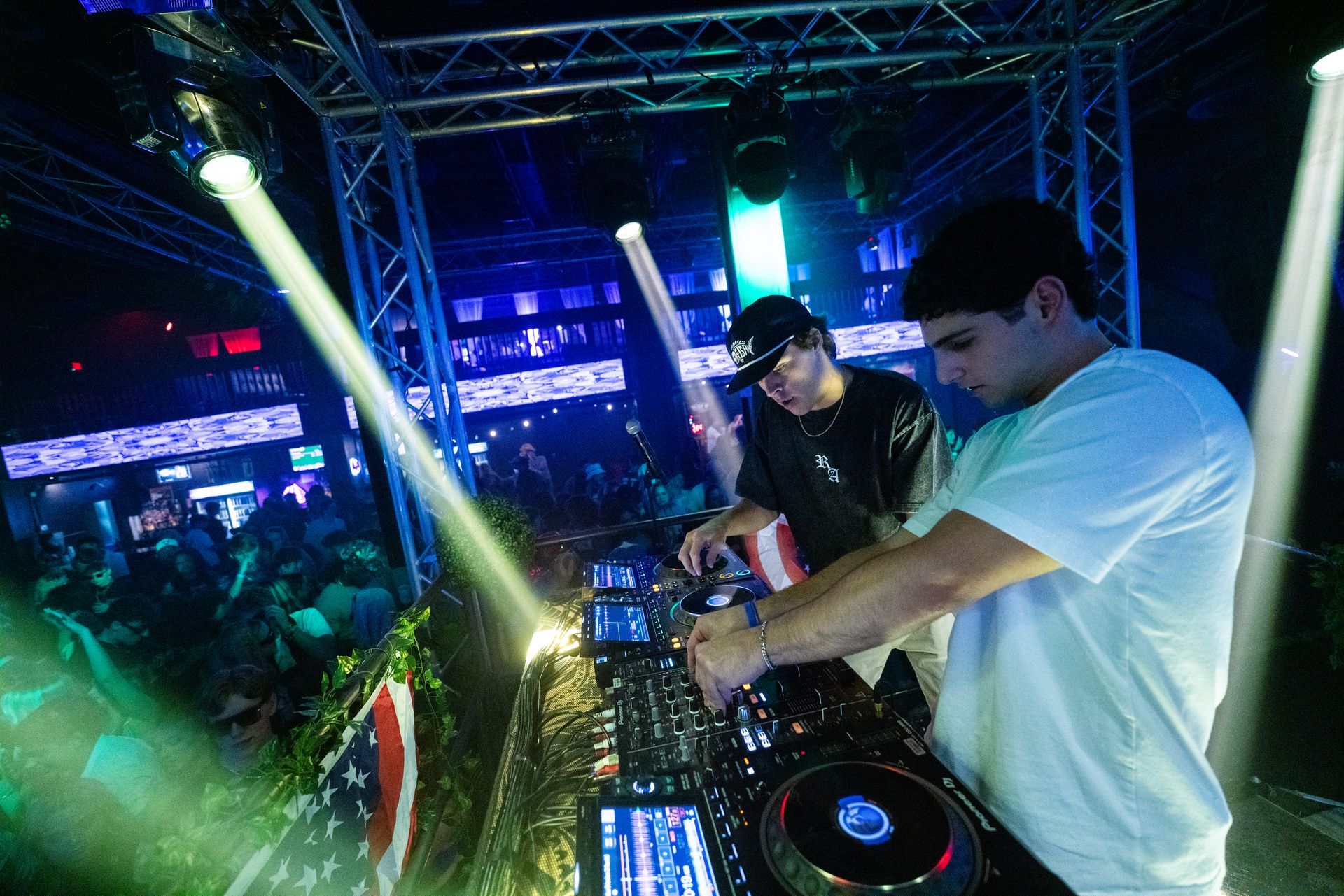 A couple of men are playing music in a club