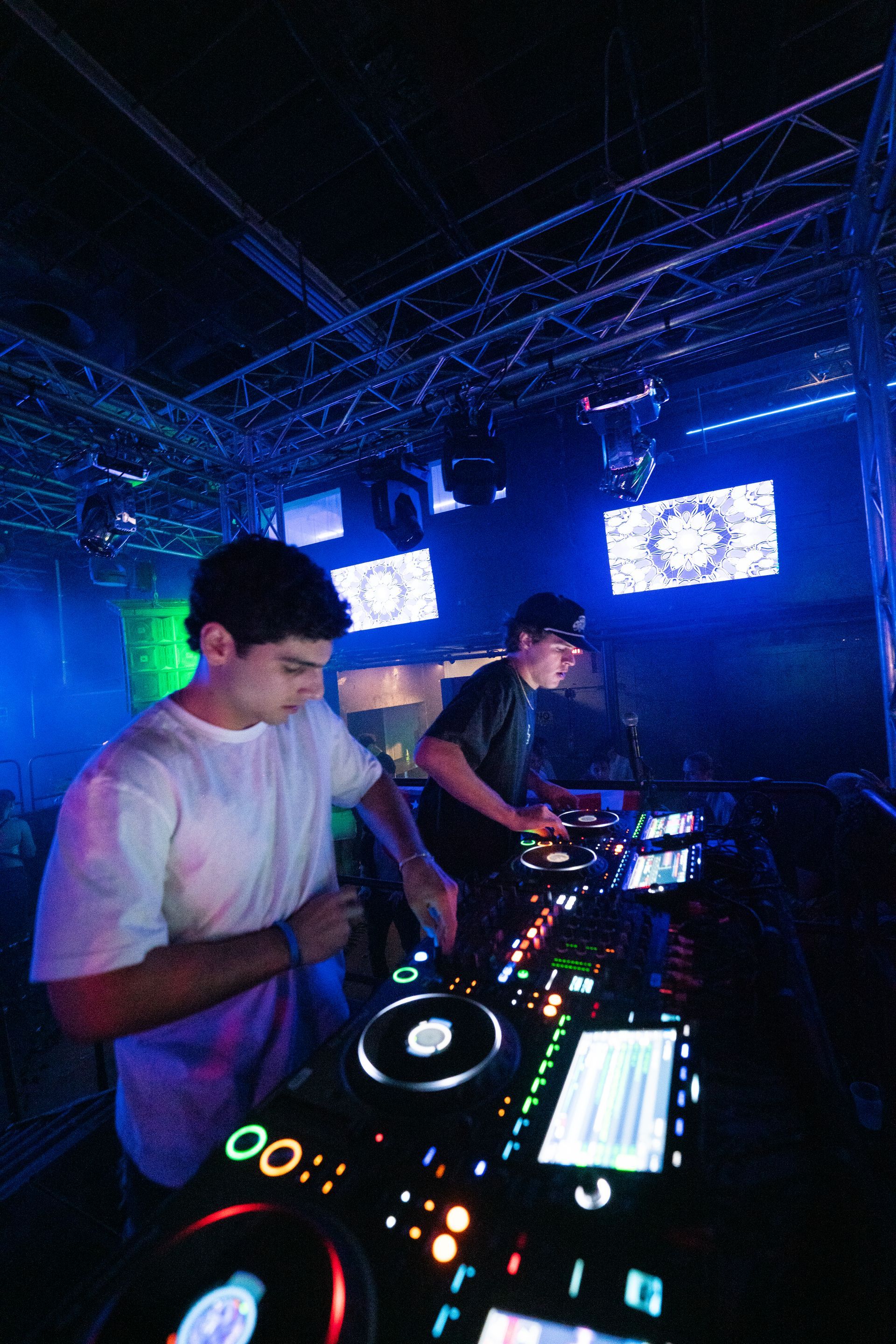 Two men are playing music in a dark room