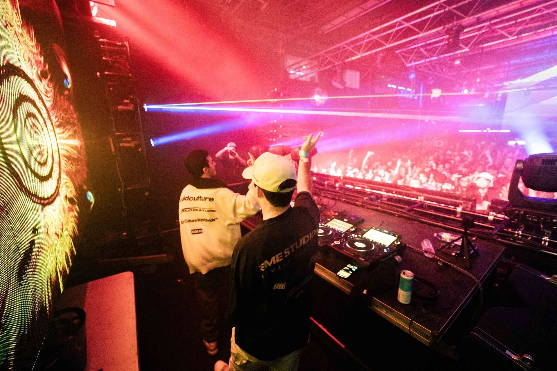 Two men are standing in front of a crowd at a concert.