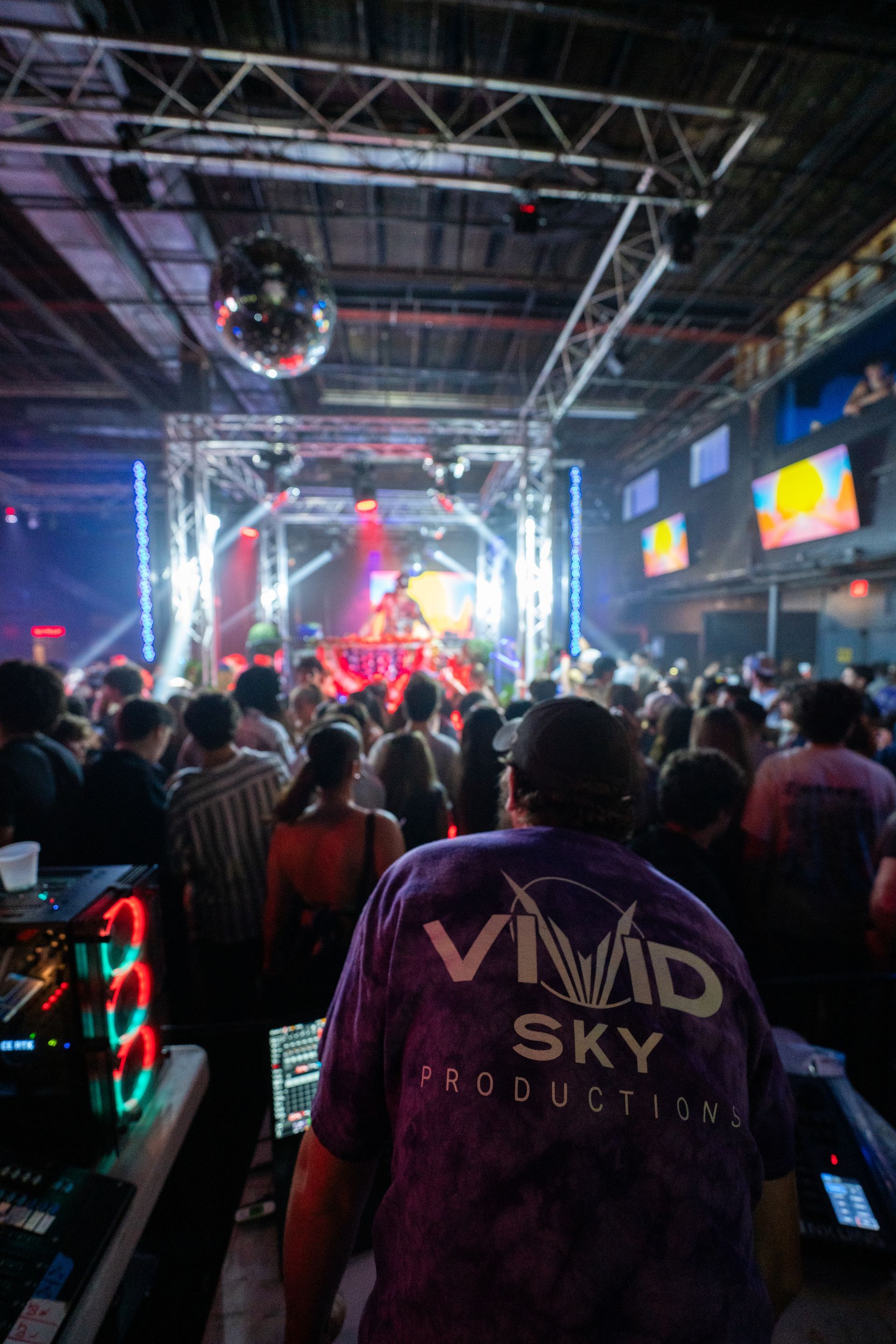A man wearing a purple shirt that says vivid sky productions