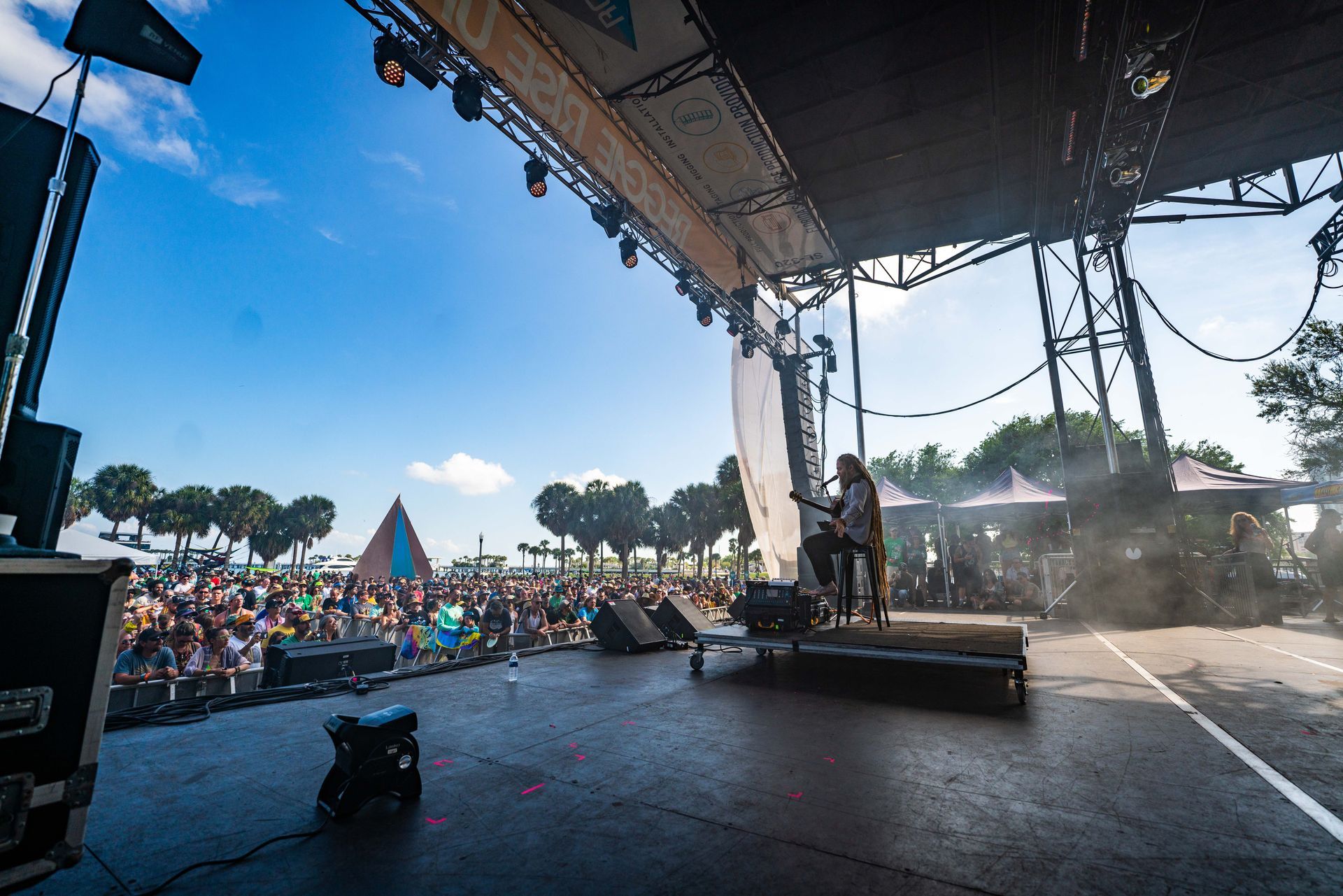 A man is playing a guitar on a stage at a concert.