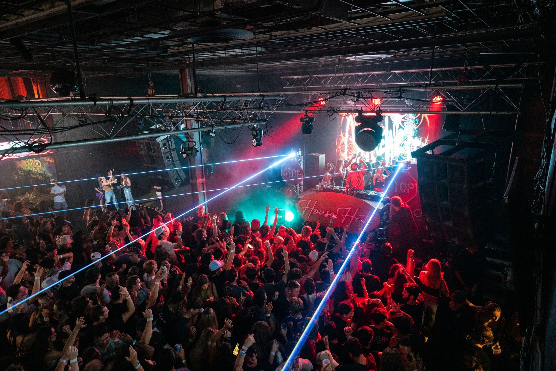 A large crowd of people are watching a band on stage
