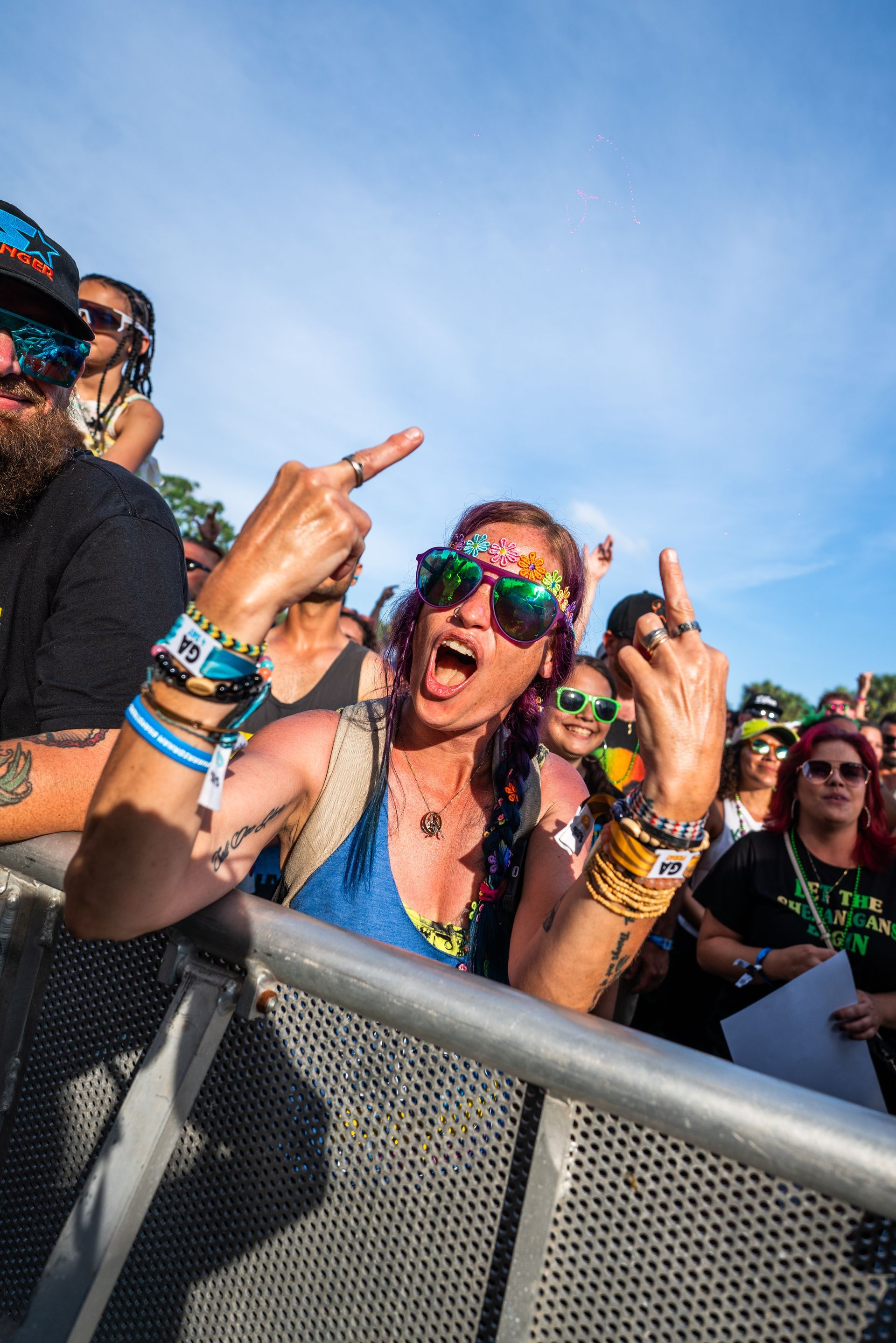 Concert going lady giving two middle fingers.