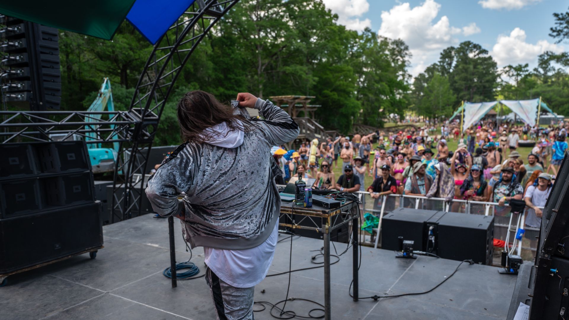 A woman is dancing on a stage in front of a crowd.