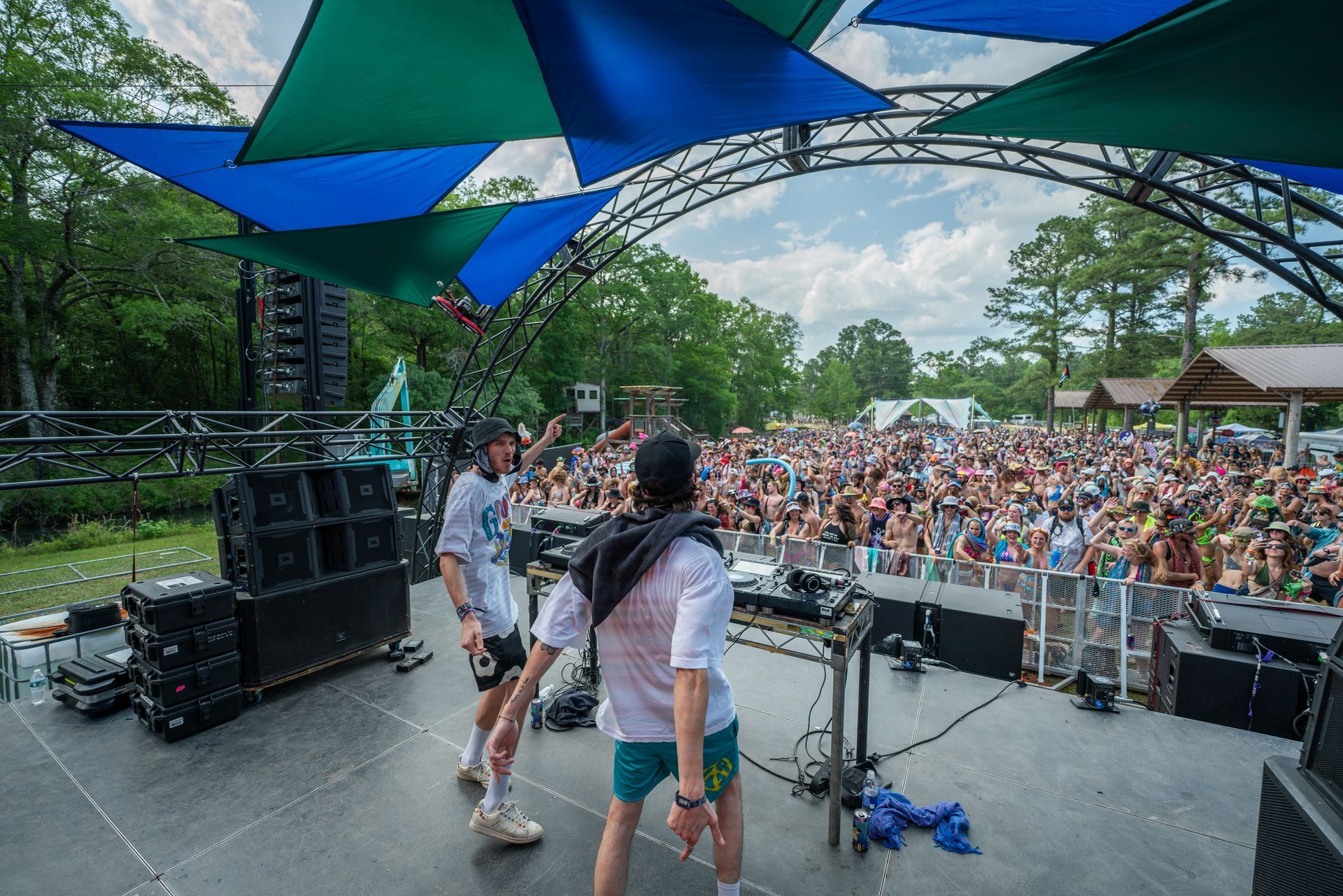 Two men are standing on a stage in front of a crowd.